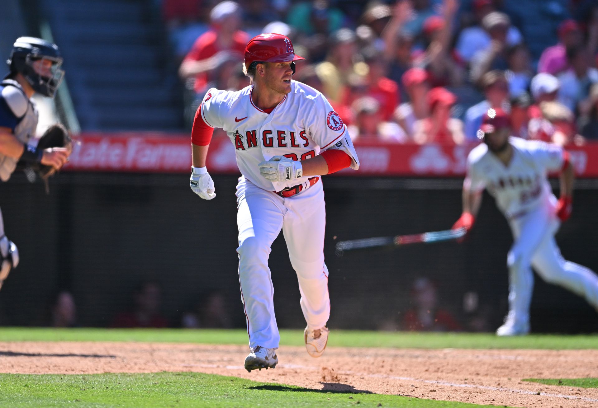 Los Angeles Angels third baseman David MacKinnon (39) breaks his bat on a RBI single in the seventh inning against the Seattle Mariners at Angel Stadium in Anaheim, California on June 26, 2022.