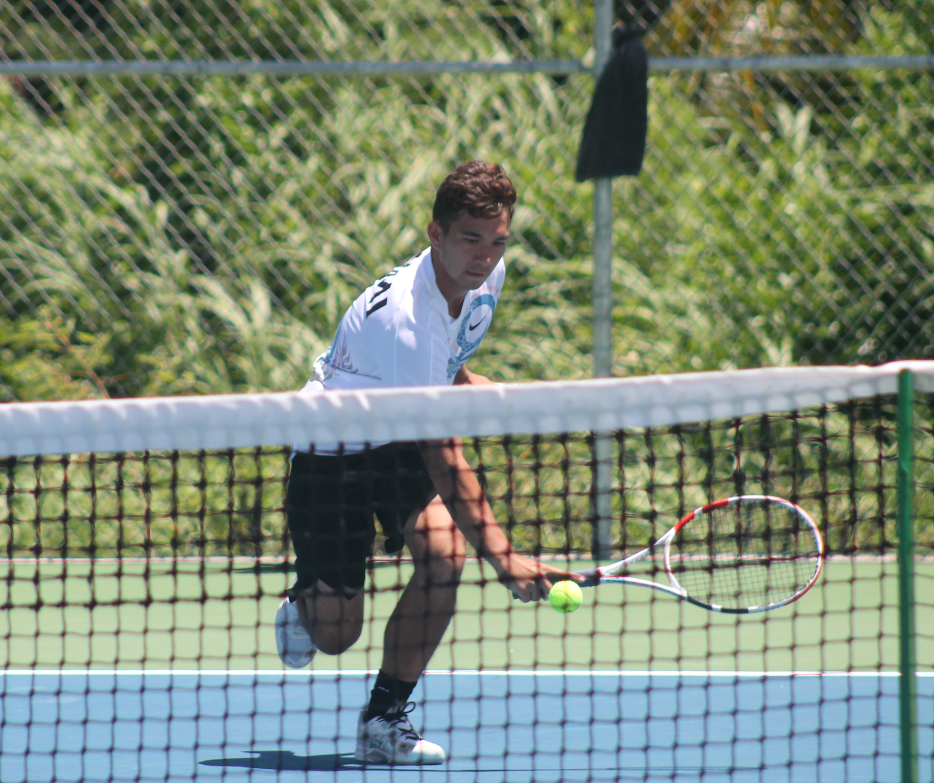 NMI tennis player Robbie Schorr reaches for the backhand return.