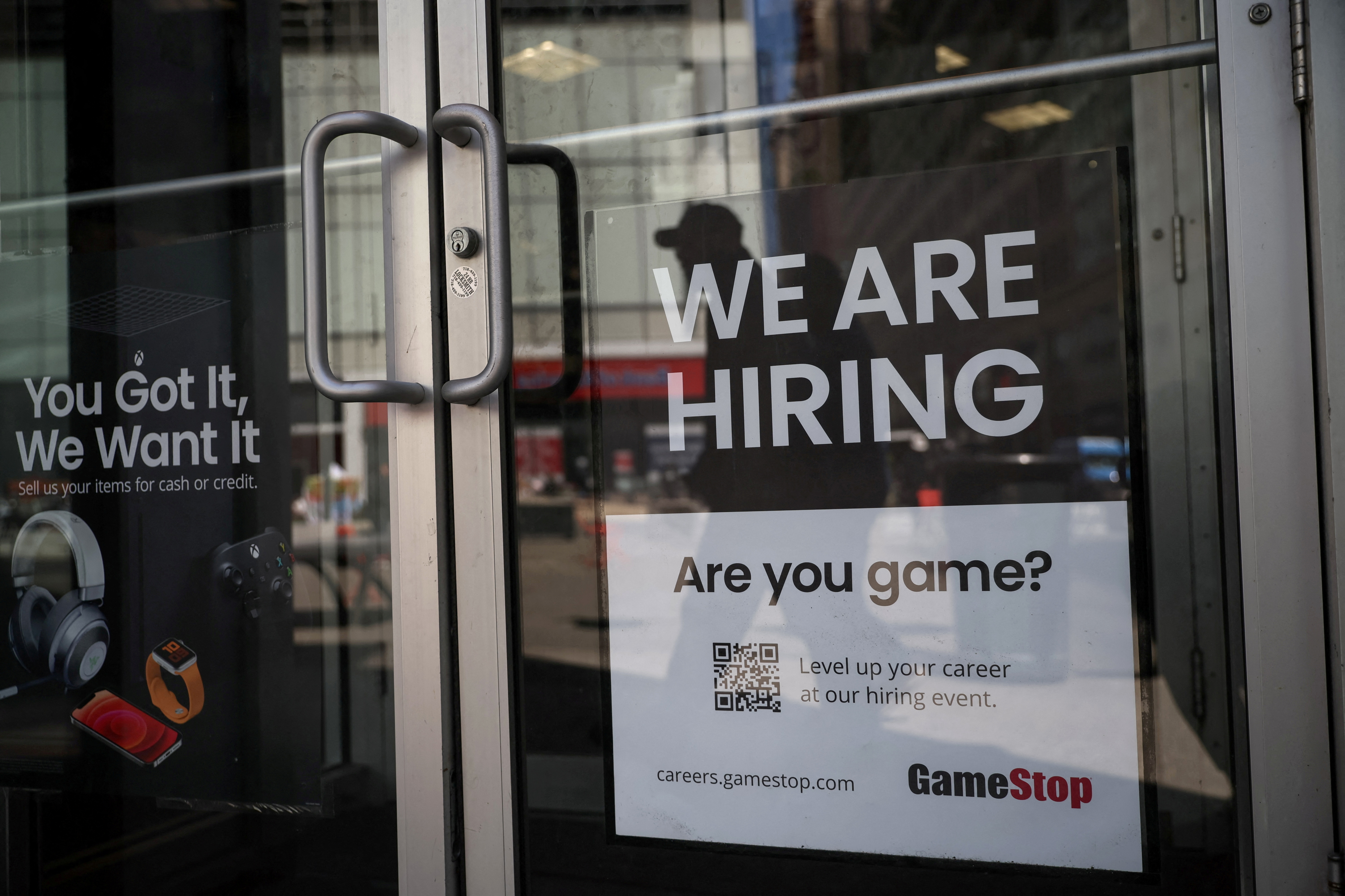 A sign for hire is posted on the door of a GameStop in New York City, April 29, 2022.