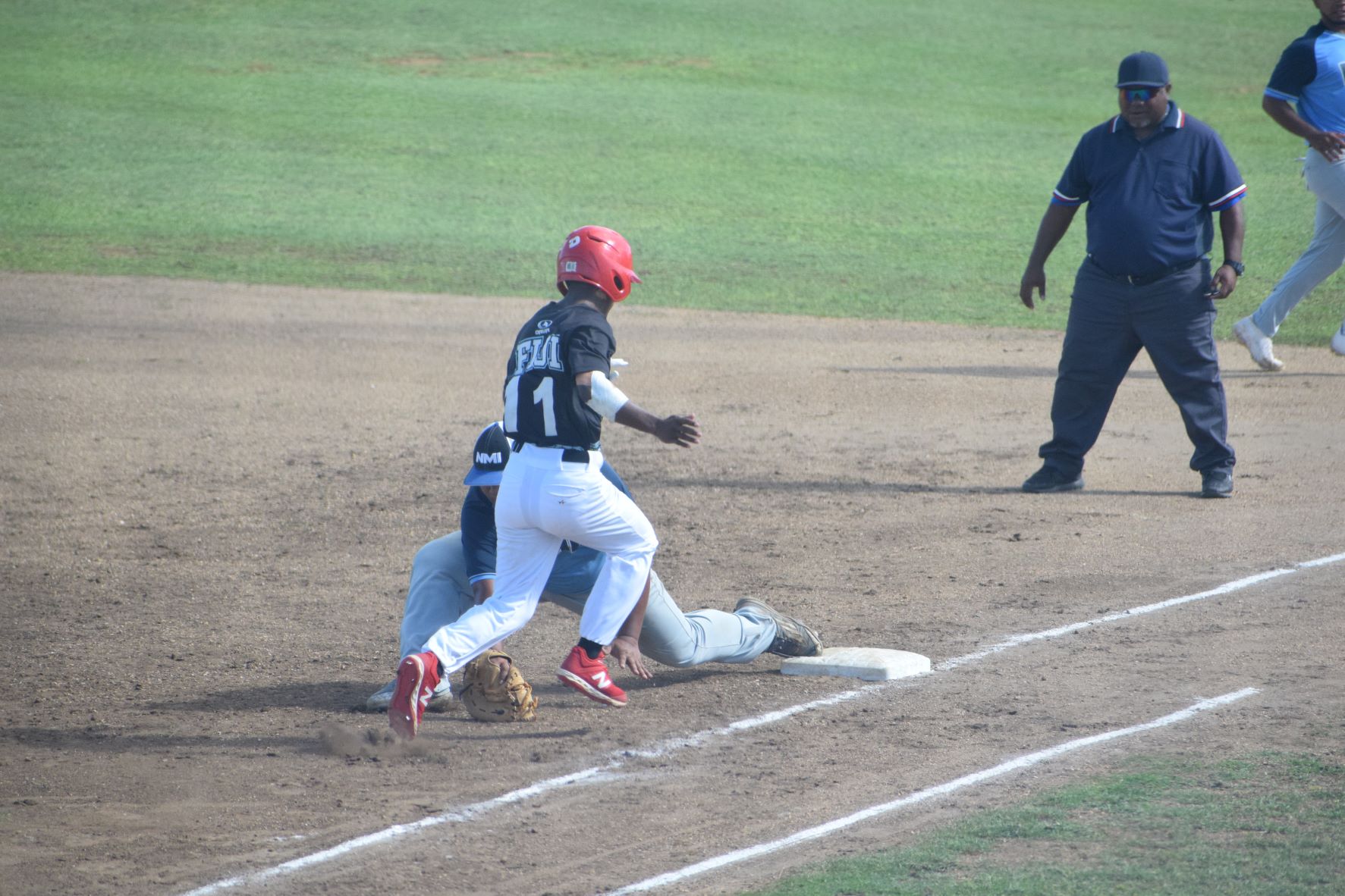 Team NMI first baseman Darion Jones tags Fiji's Raiqueu Jakope in the fourth inning of a Pacific Mini Games baseball game at the Tan Ko Palacios Baseball Field on Monday.