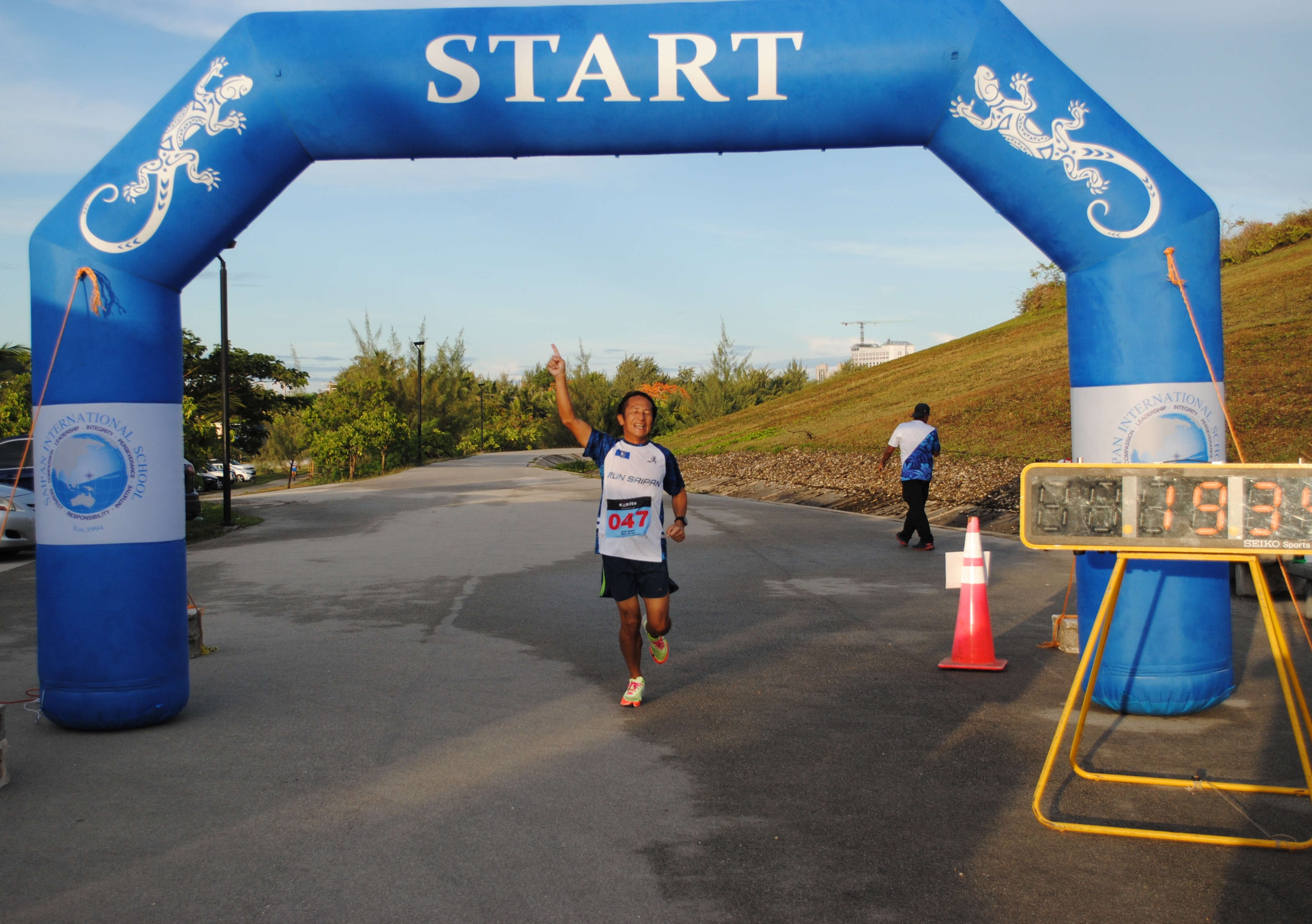 Kosuke Sato celebrates as  he crosses the finish line of Run Saipan’s 2nd Mangrove 5K race Saturday at the Gov. Eloy S. Inos Peace Park.