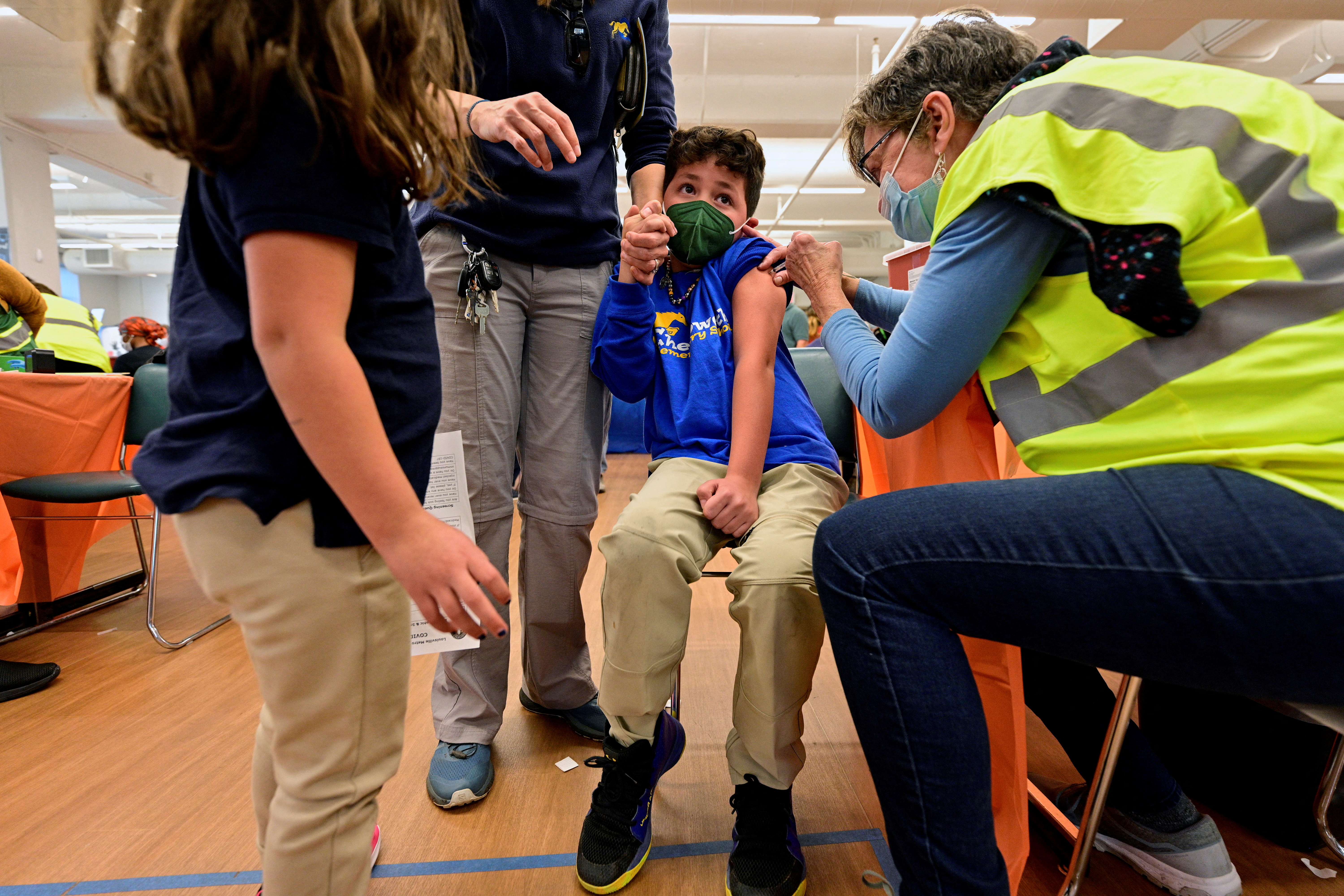 A child reacts while receiving a dose of the Pfizer-BioNTech coronavirus disease vaccine at Smoketown Family Wellness Center in Louisville, Kentucky, Nov. 8, 2021.