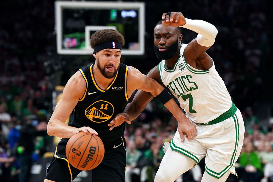 Golden State Warriors guard Klay Thompson (11) dribbles the ball against Boston Celtics guard Jaylen Brown (7) during the first quarter of game four in the 2022 NBA Finals at the TD Garden in Boston, Massachusetts on June 10, 2022.