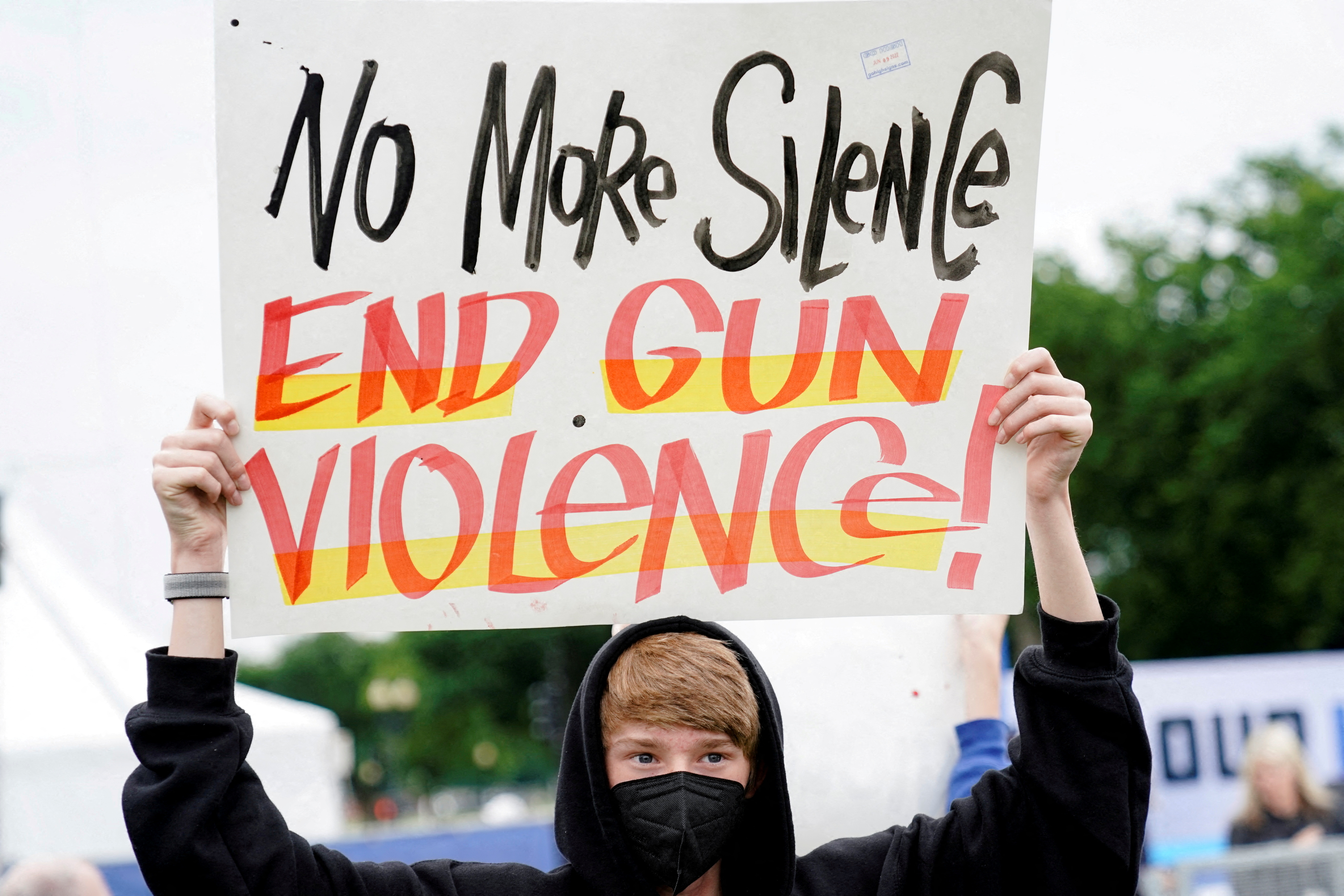 A demonstrator holds a placard while taking part in the “March for Our Lives,” one of a series of nationwide protests against gun violence, in Washington, D.C., June 11, 2022.