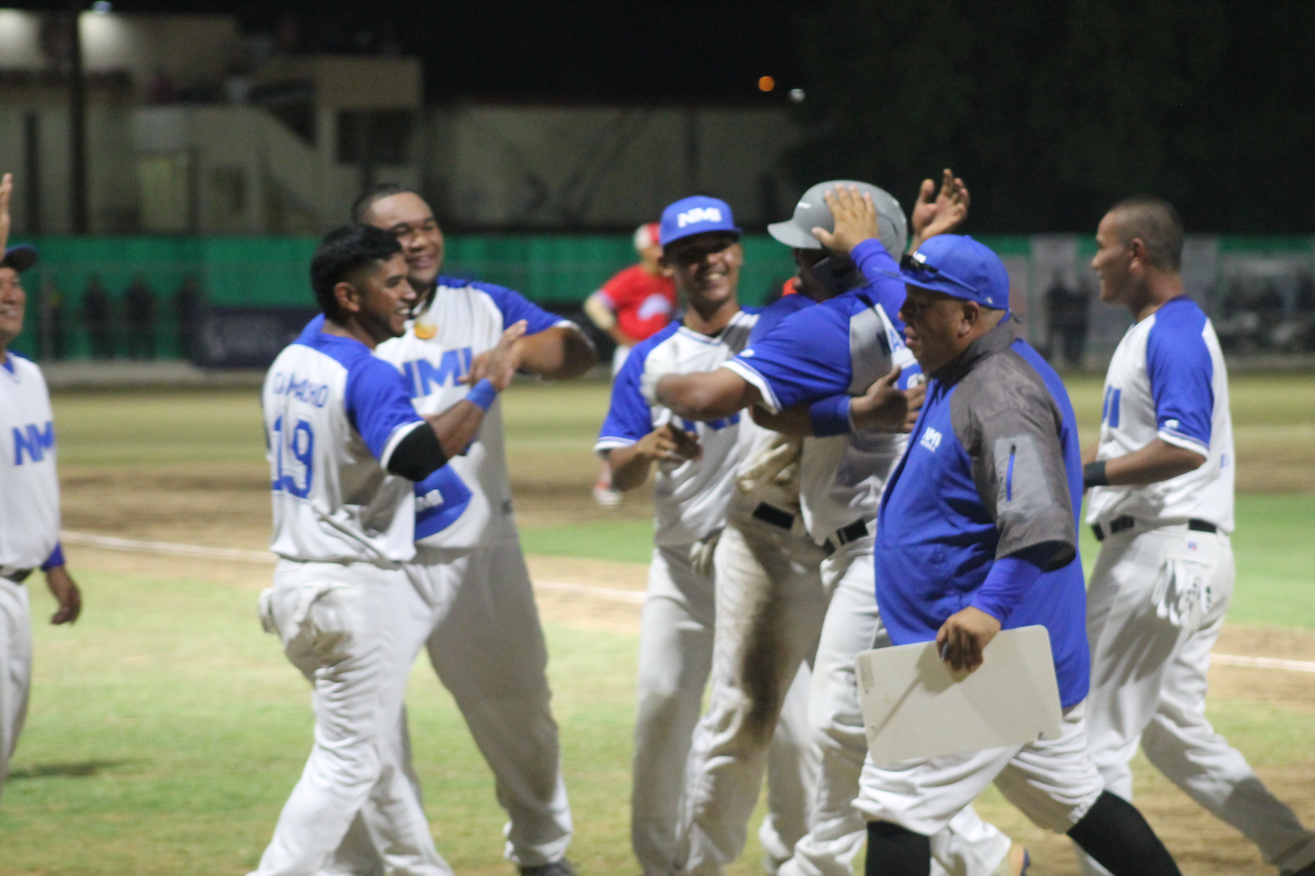 The NMI baseball team celebrates after Franko Nakamura's solo homerun.