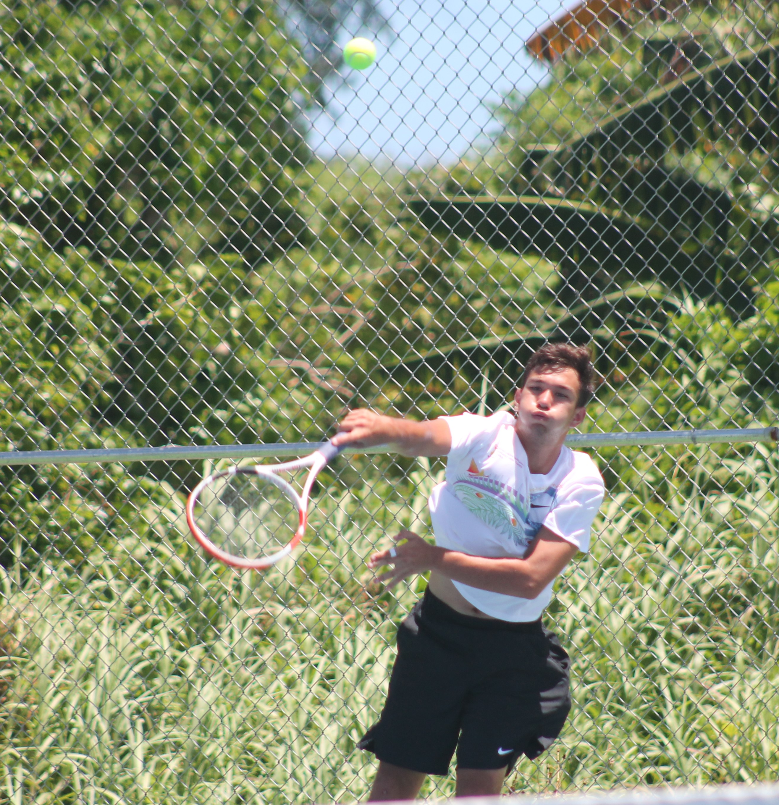 Robbie Schorr of the NMI connects the serve against Kiribati during the opening Pacific Mini Games tennis match Thursday against Kiribati at an American Memorial Park tennis court.