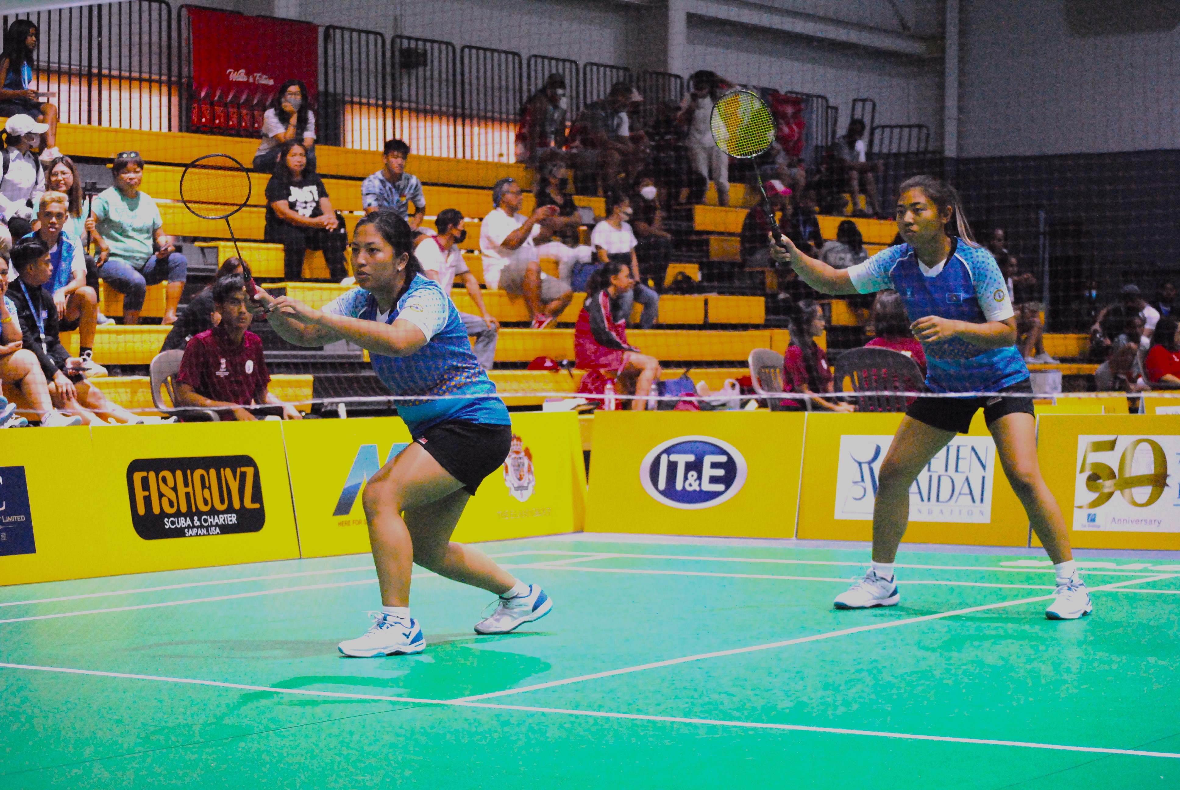 The NMI's Janelle Pangilinan and Jenine Savellano prepare for the incoming serve during a 2022 Pacific Mini Games badminton match at the Ada gym.
