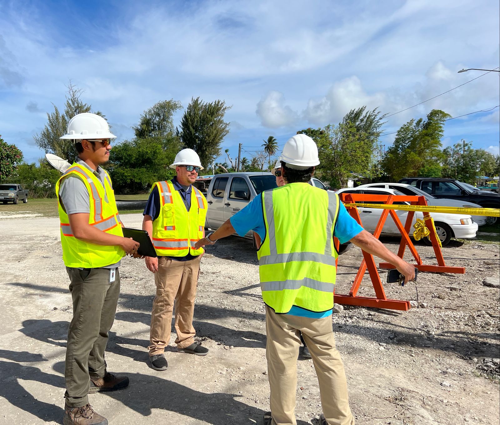 From left, Keith Kintol, IRP inspector; Mike Fields, CBDG-DR inspector; and Rex Richa- Yachtze, project foreman discuss the asphalt removal and replacement for Apengahg Avenue and Ghillis Street as part of a drainage improvement project on May 19, 2022.