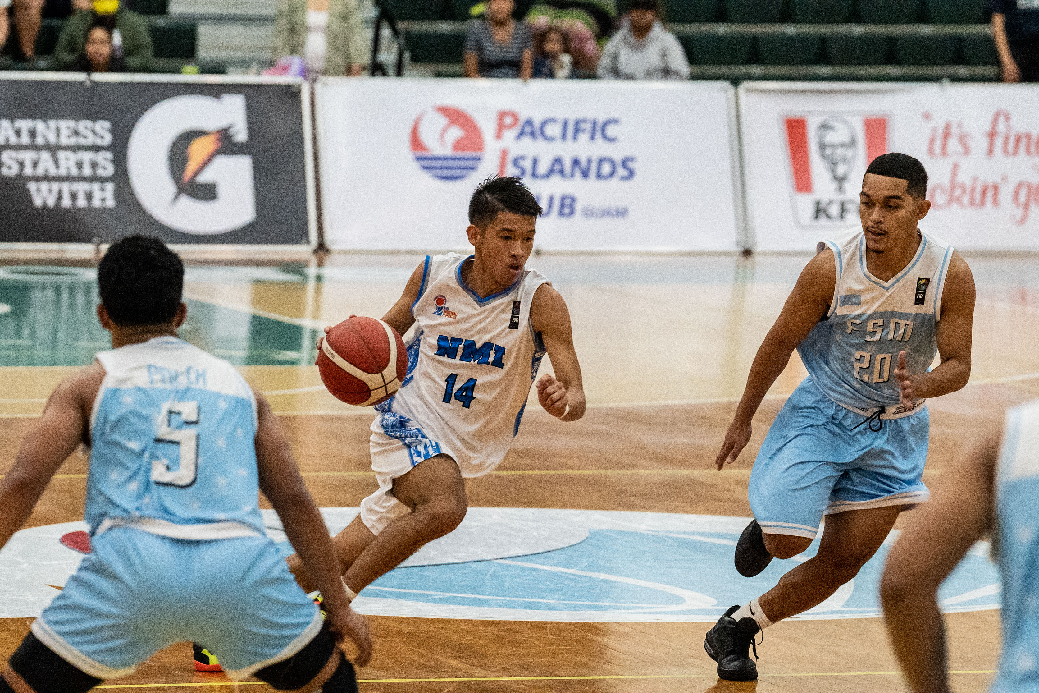 NMI's Leo Naraja drives toward the hoop.