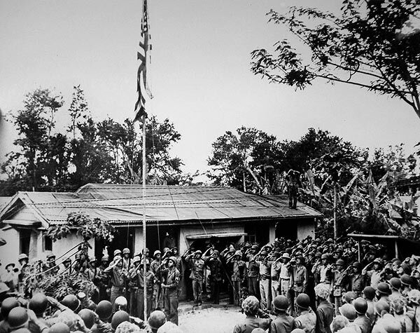 U.S. servicemembers hold a flag- raising ceremony in Chalan Kanoa village on July 10, 1944. With this event, the Northern Marianas came under the control and administration of the U.S. Navy.