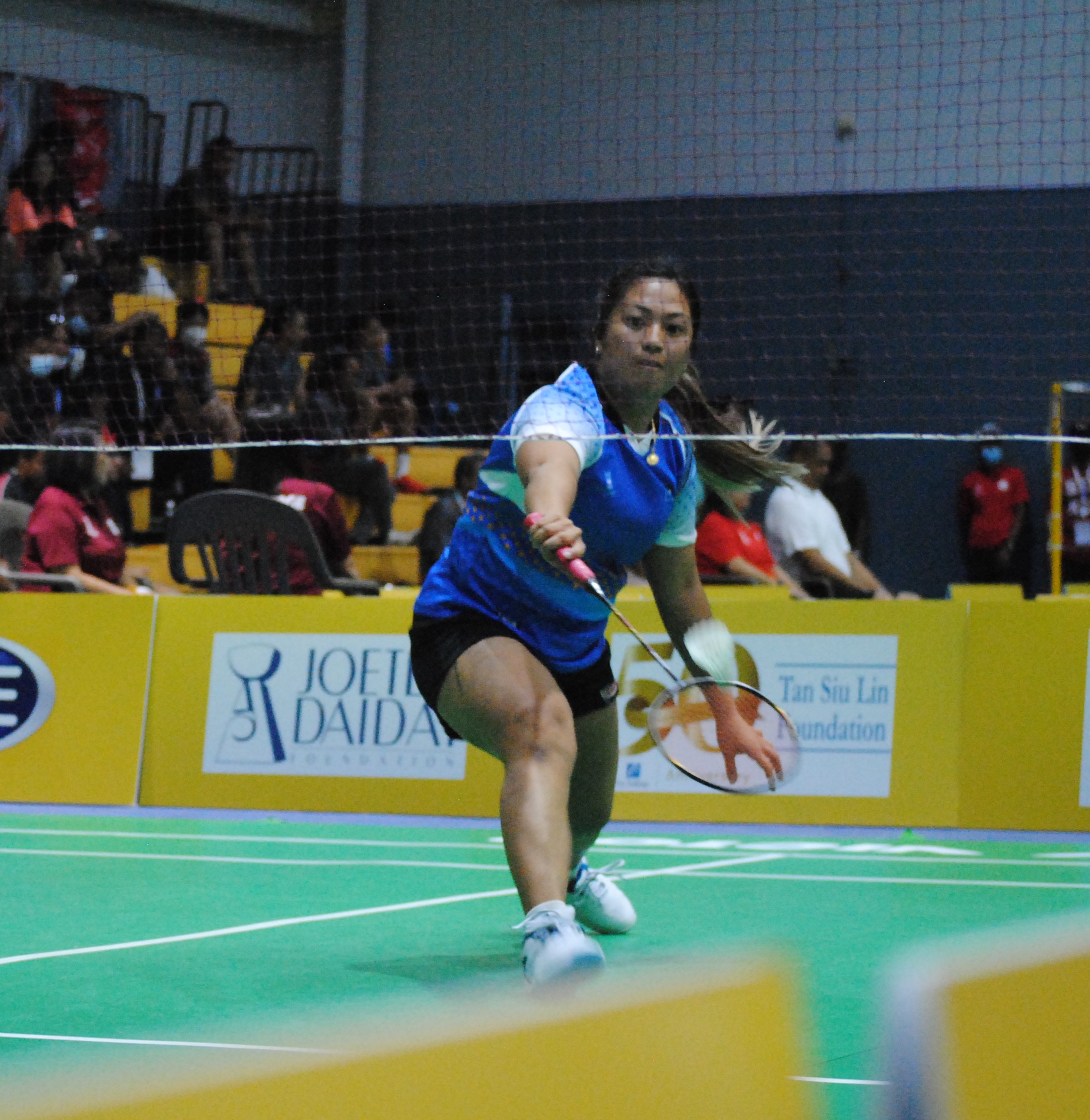 The NMI's Janelle Pangilinan extends for the return during a badminton match Monday in the 2022 Pacific Mini Games at the Ada gym.