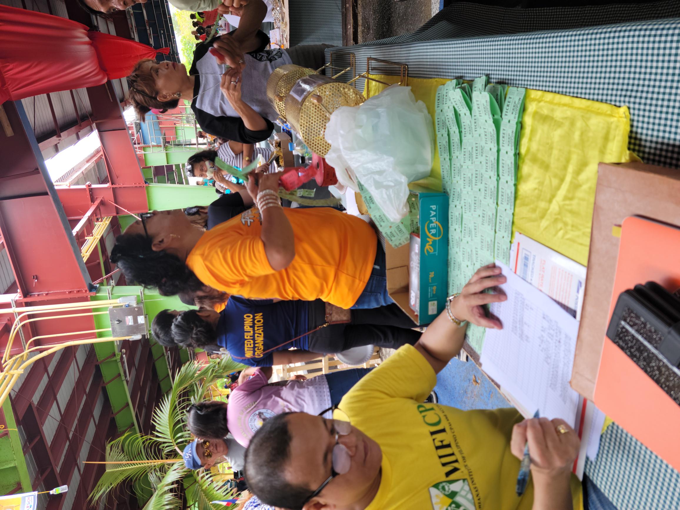 United Filipino Organization members sell raffle tickets during “Pistang Pinoy 2022” at Marianas Business Plaza.