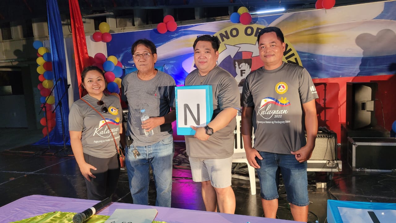 From left, United Filipino Organization secretary Birhen K. Martinez, Rogelio Bince, the  “Pera o Kahon” or “Cash or Box” contest winner, RV Caberos, event emcee, and UFO president Marcelo “Mar” Masilungan pose for a photo.