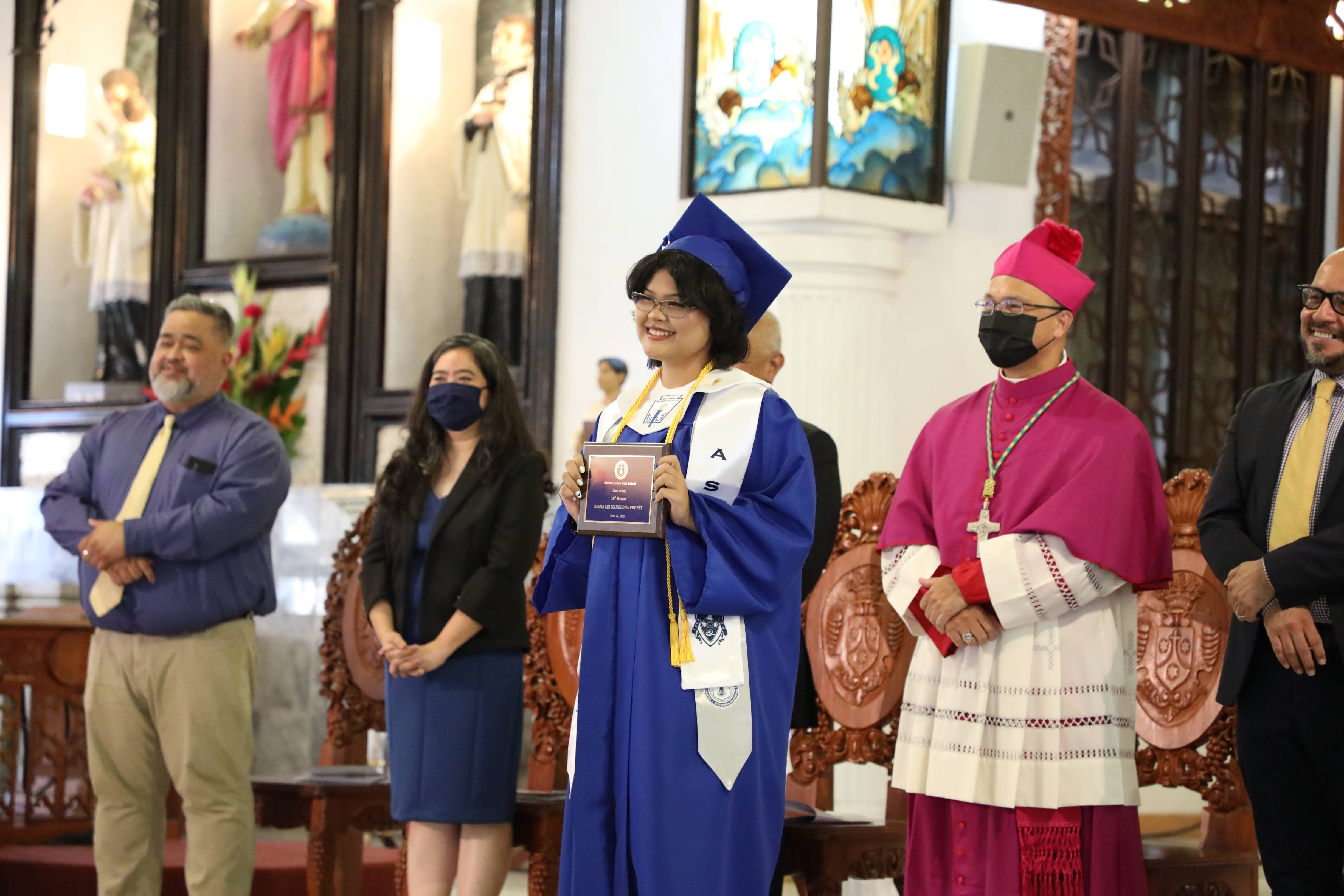 Mount Carmel School student Kiana Lei Manglona Propst receives her diploma during the school’s 12th-grade commencement ceremony on June 4, 2022.