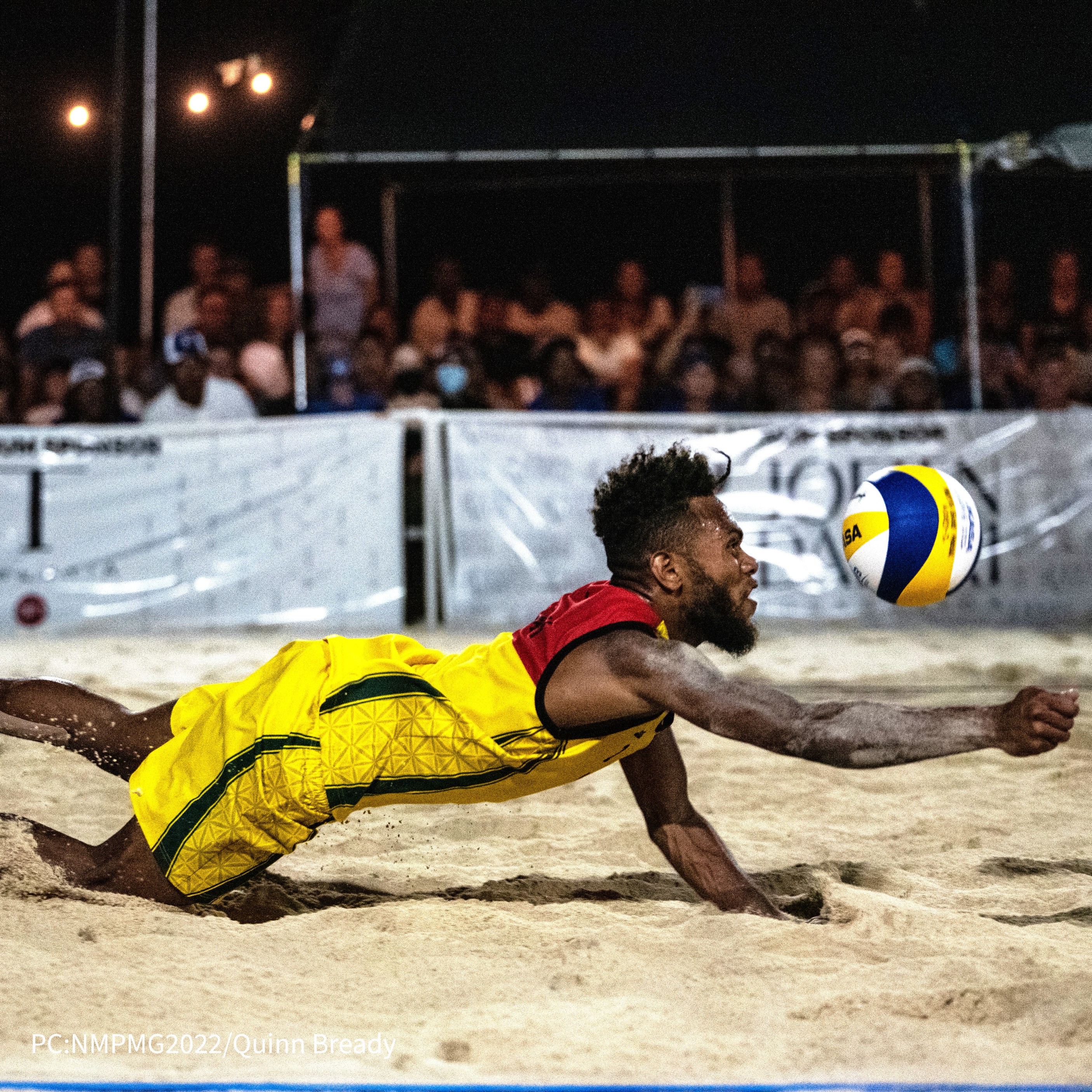 Vanuatu's James Chilia dives for the save during the beach volleyball championship match against the NMI.