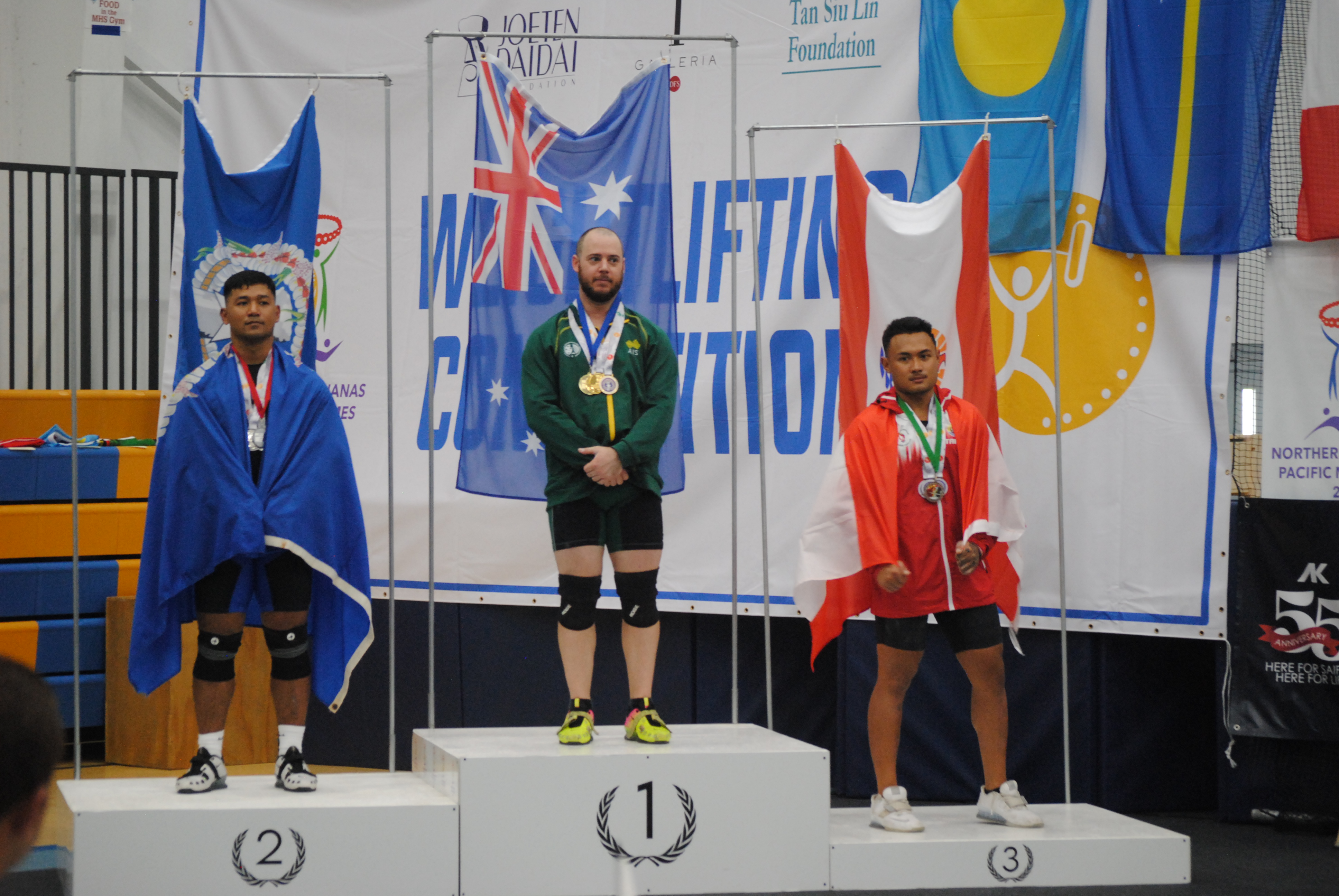 The NMI’s Leonardo Apelo, left, Beau Garrett of Australia, center, and Matahi Tahiaipuoho of Tahiti at the medal ceremony  for the 89kg weightlifting event of the 2022 Pacific Mini Games Wednesday at the MHS gym.