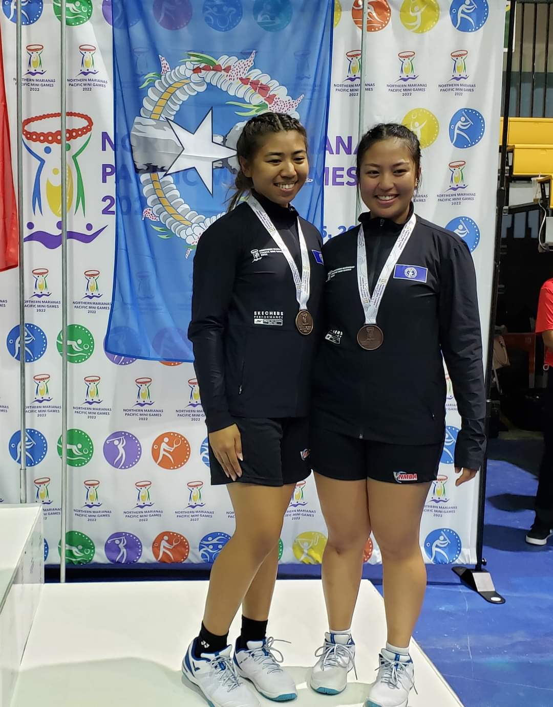 The NMI's Janelle Pangilinan, right, and Jenine Savellano earned a bronze medal in the 2022 Pacific Mini Games women's doubles badminton event after defeating Tahiti's Waianuhea Teheura and Hortensia Manzanal, 21-12, 21-9, Saturday at the Ada gym.
