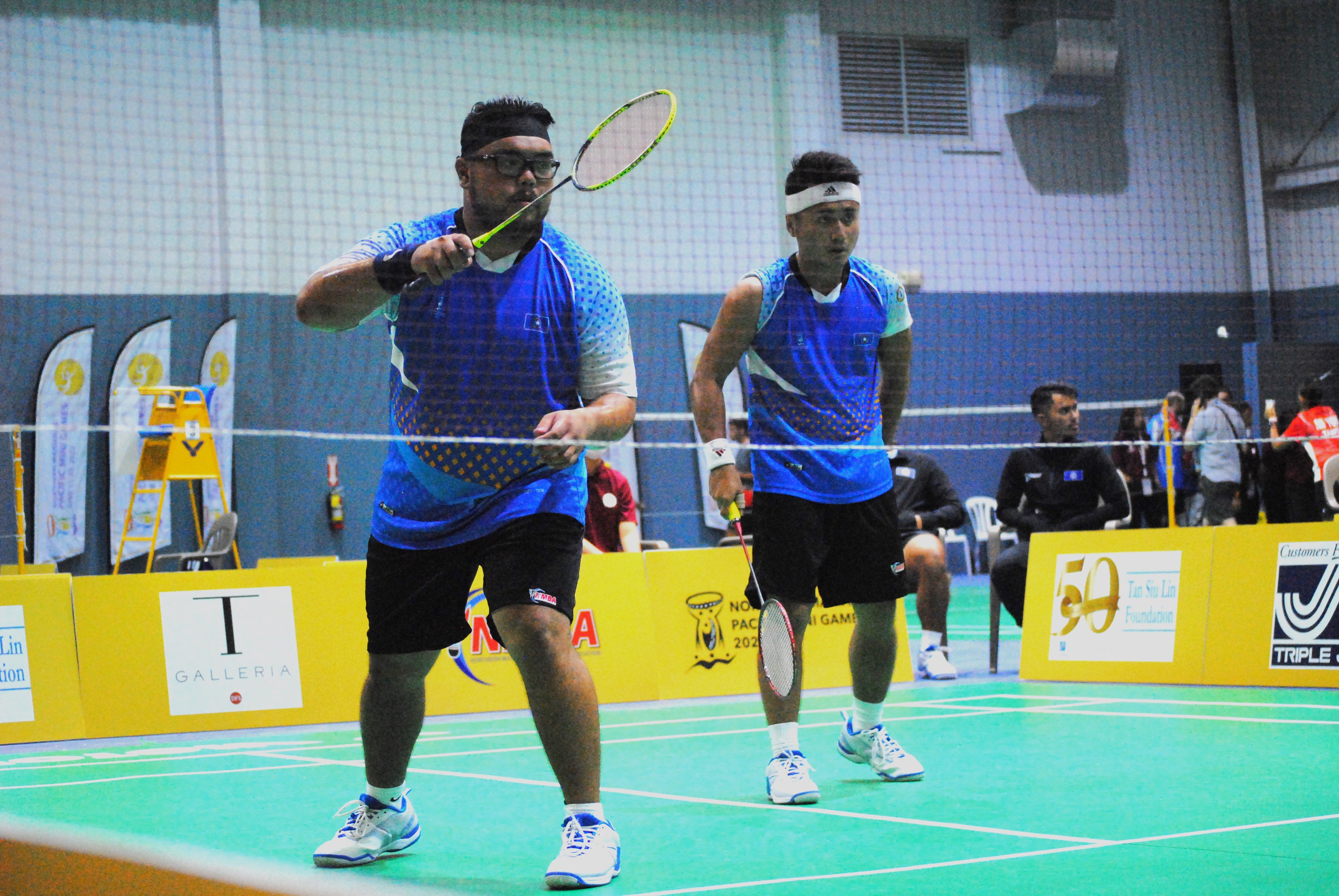 NMI badminton players Jordan Pangilinan and Andreau Galvez prepare for an incoming serve.