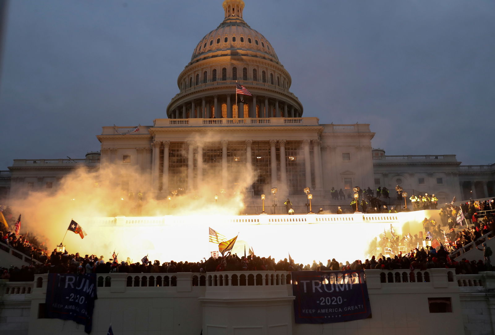 An explosion caused by a police munition is seen while supporters of President Donald Trump gather in front of the U.S. Capitol in Washington, D.C., Jan. 6, 2021.