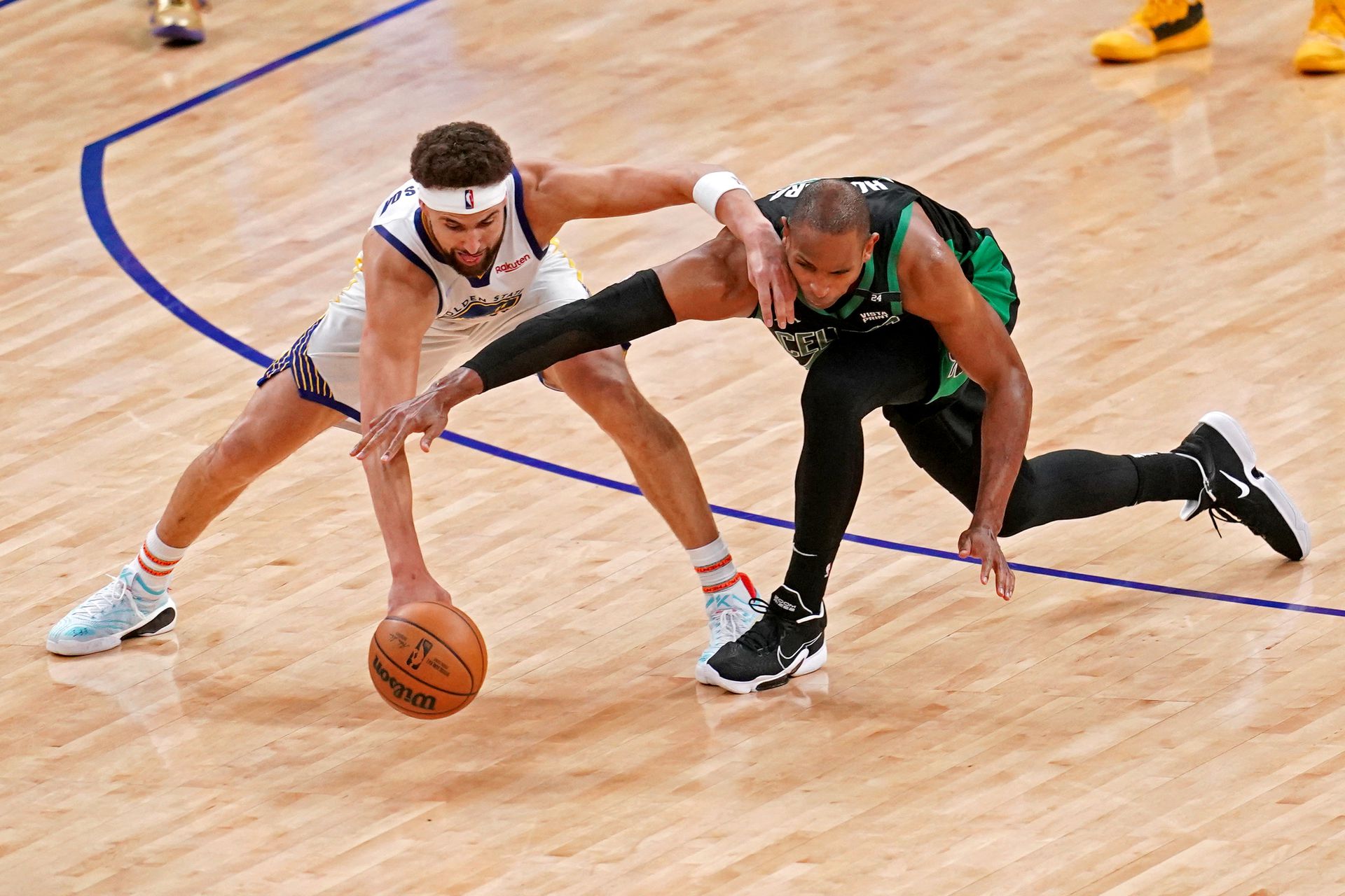Golden State Warriors guard Klay Thompson (11) and Boston Celtics center Al Horford (42) go for the ball during the fourth quarter in game five of the 2022 NBA Finals at Chase Center in San Francisco, California on June 13, 2022.