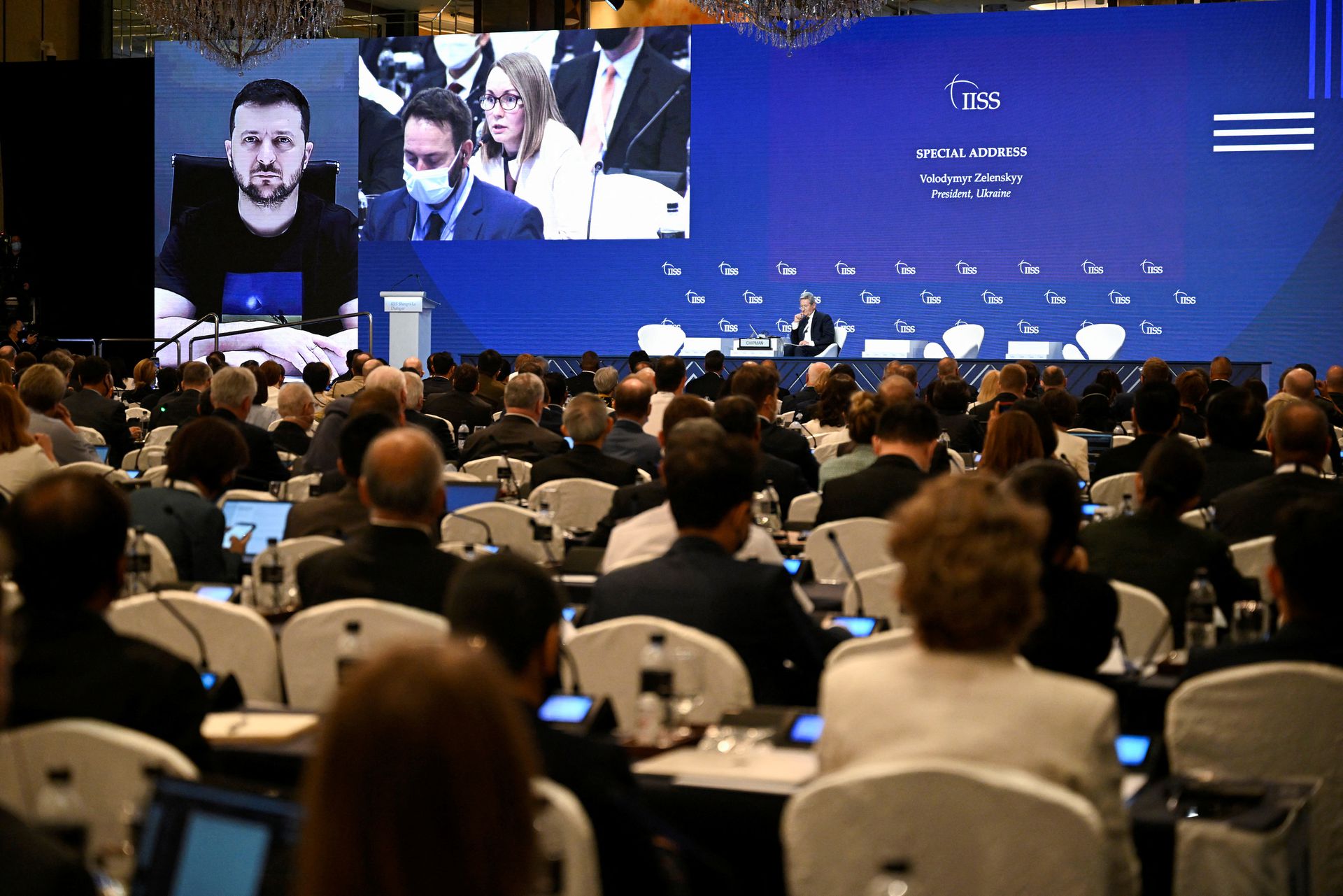 Ministers and delegates listen to a virtual special address by Ukraine's President Volodymyr Zelenskiy at the 19th Shangri-La Dialogue in Singapore, June 11, 2022.