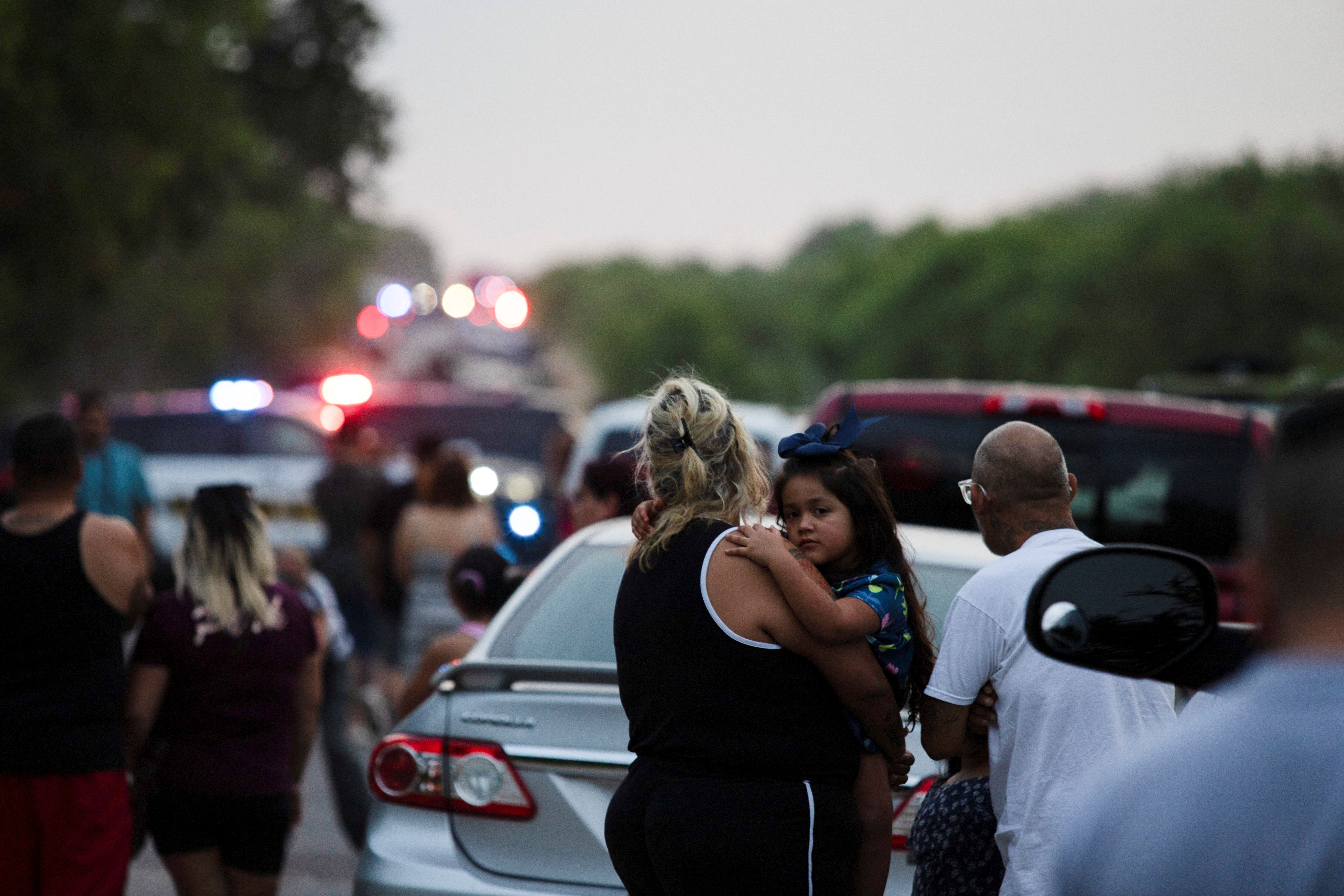 Rose Perez holds her mother Scarlet Chavez at the scene where people were found dead inside a trailer truck in San Antonio, Texas, June 27, 2022. 