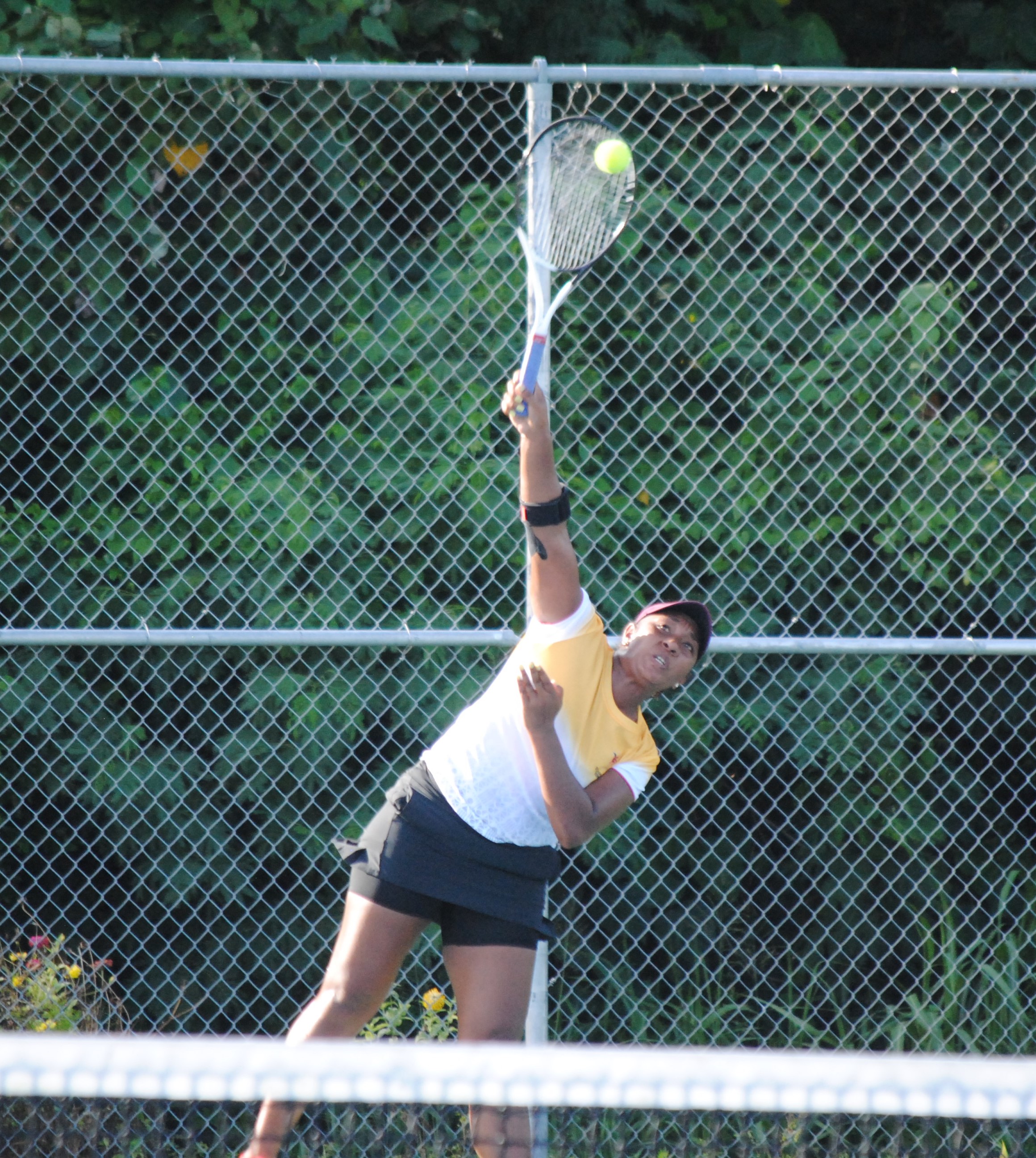 PNG's Abigail Tere-Apisah connects the overhand serve during the 2022 Pacific Mini Games tennis gold medal match Saturday at an American Memorial Park tennis court.