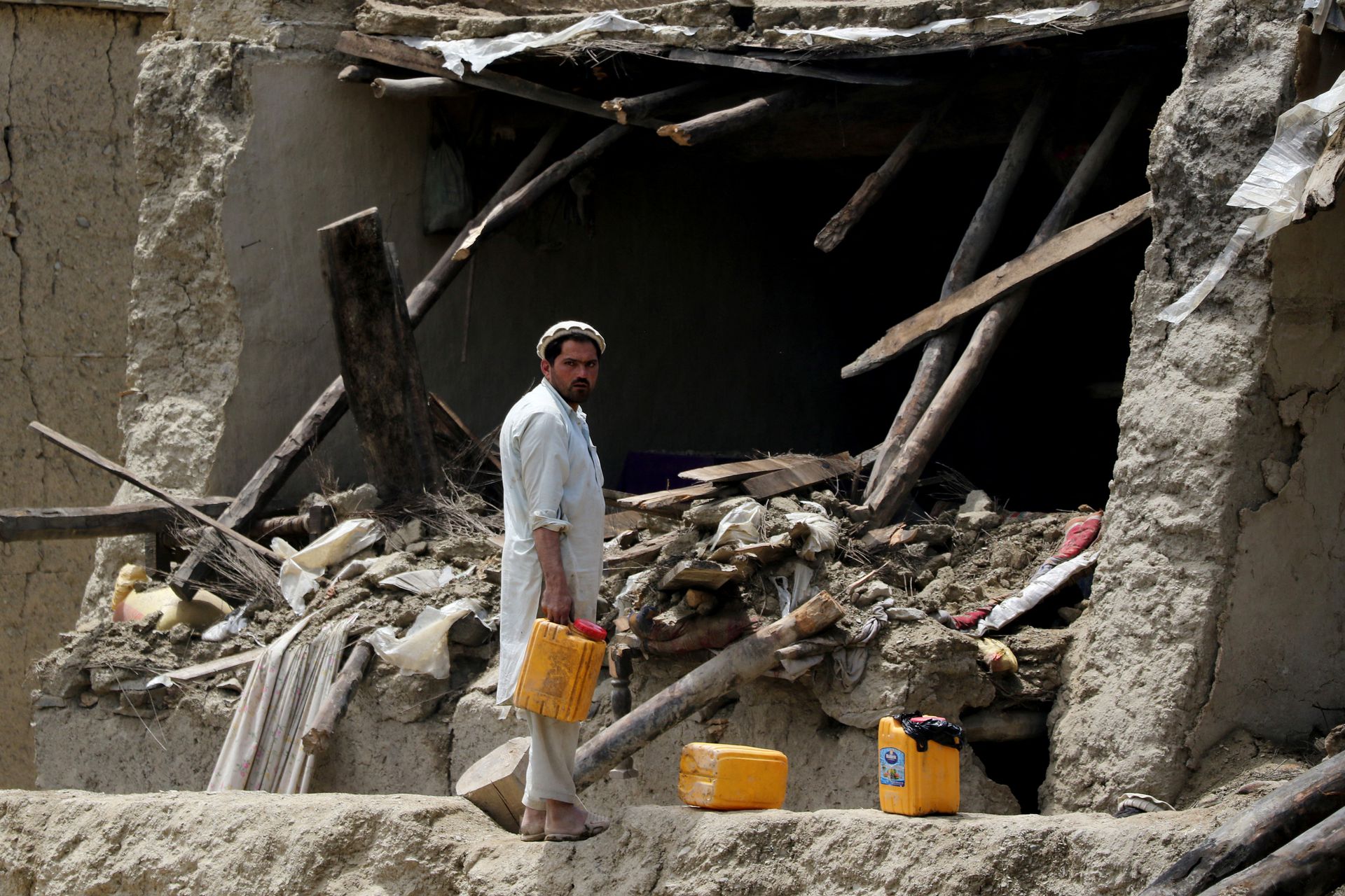 An Afghan man looks on in front of a damaged property after a recent earthquake in Gayan, Afghanistan, June 23, 2022.