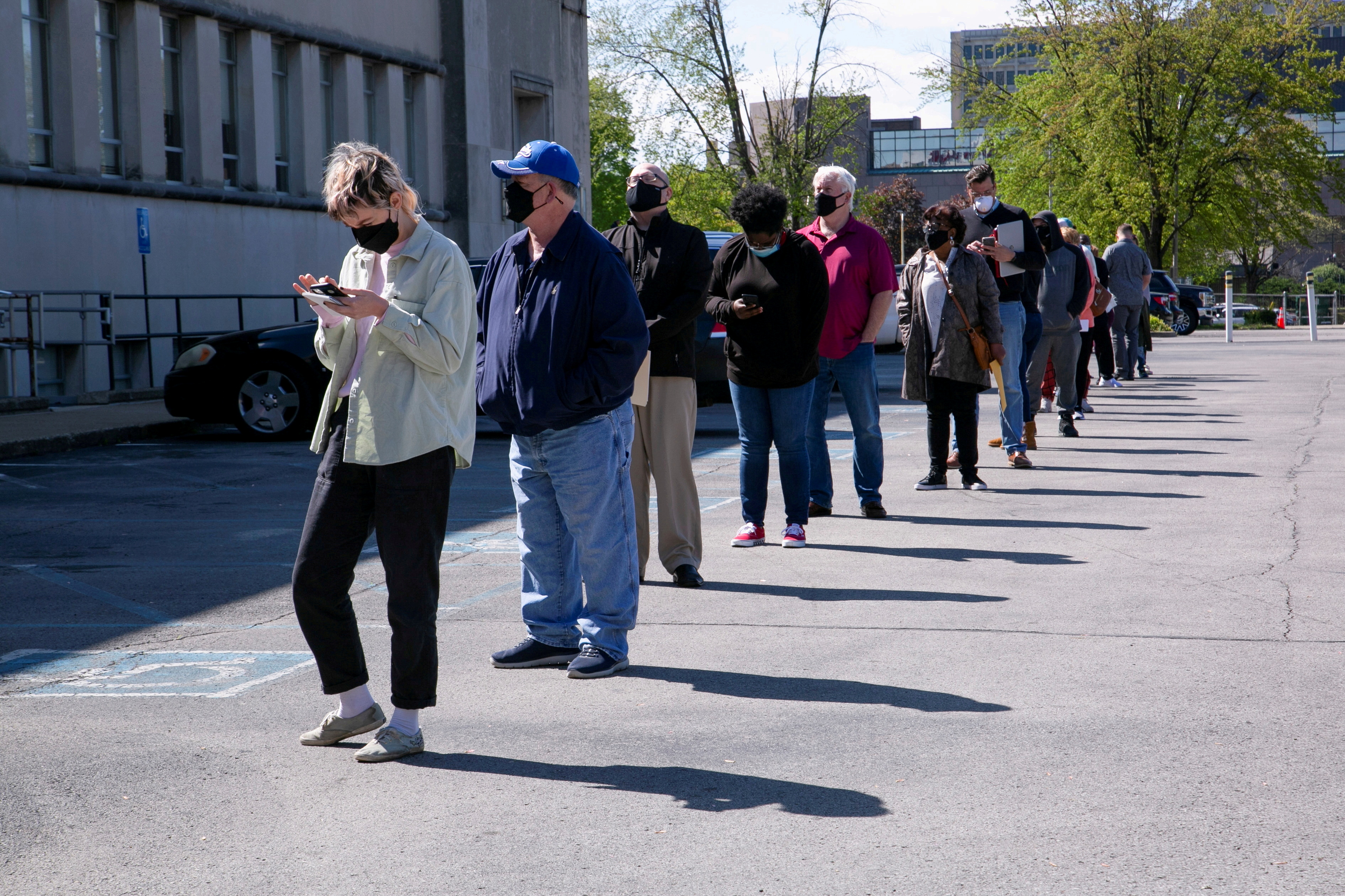 People line up outside a newly reopened career center for in-person appointments in Louisville, April 15, 2021.