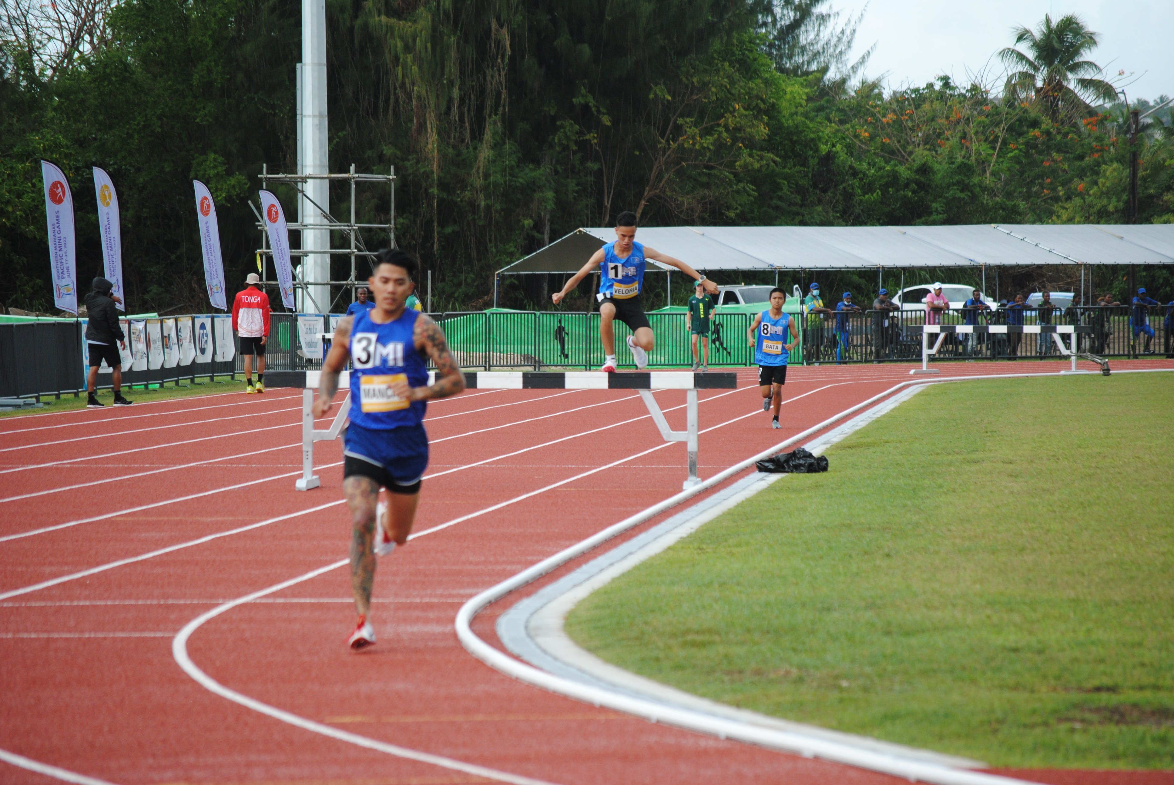 The NMI’s Michael Mancao, Sildrey Veloria and Zyrus Bata make their way through a barrier in the athletics men's 3000m steeplechase event.