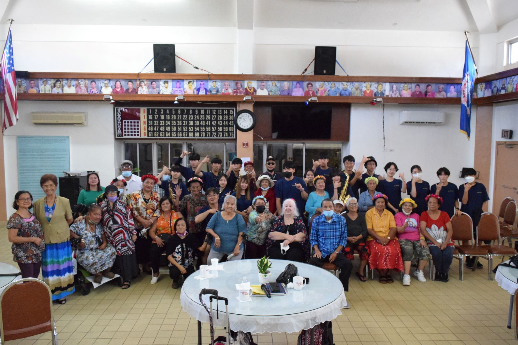 Members of the South Korean Global Education Oriented School's saxophone ensemble pose for a photo with senior citizens after a mini-concert at the Manamko' Center on Friday.