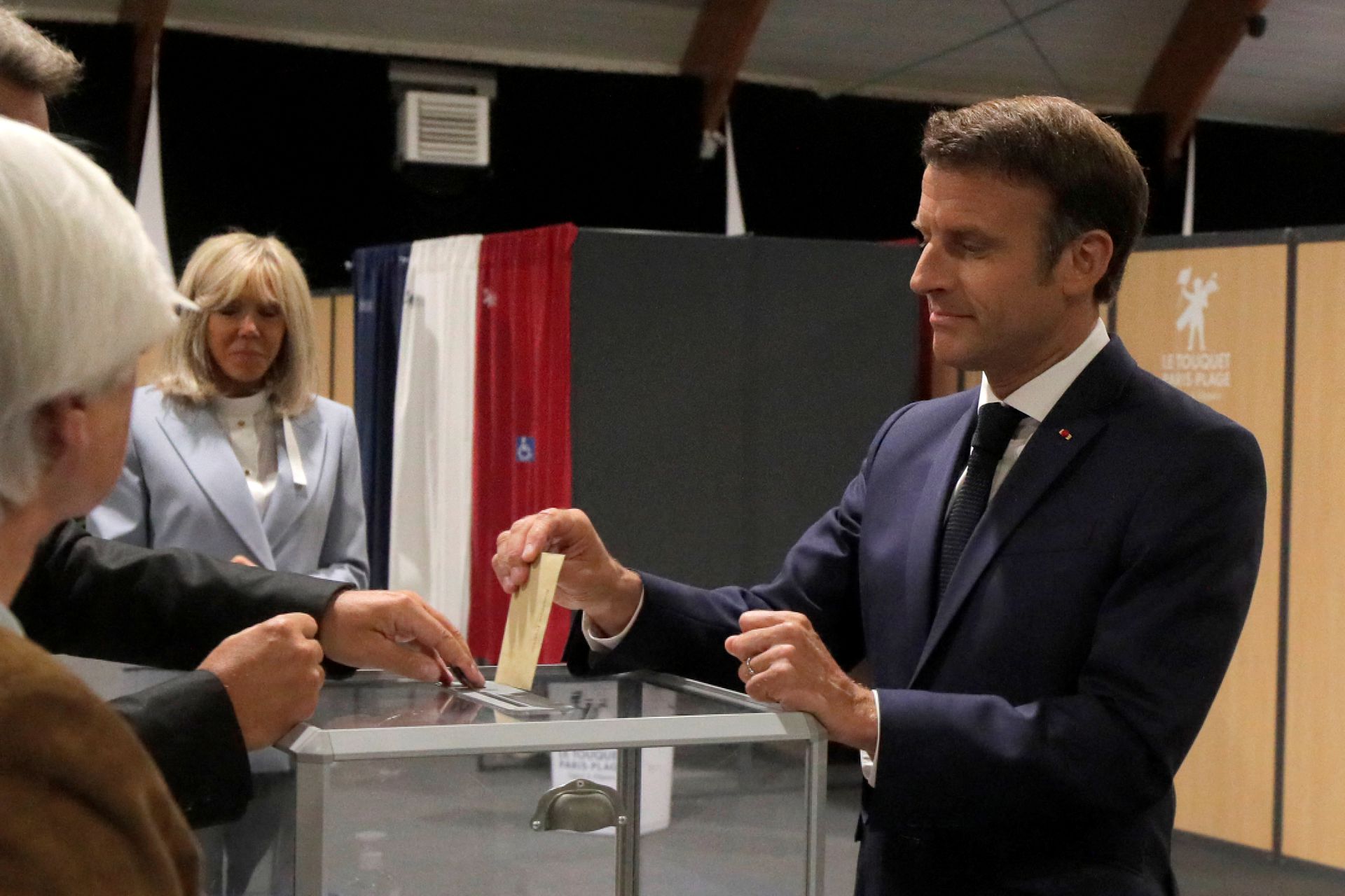 French President Emmanuel Macron casts his ballot during the final round of the country's parliamentary elections, in Le Touquet, France, June 19, 2022