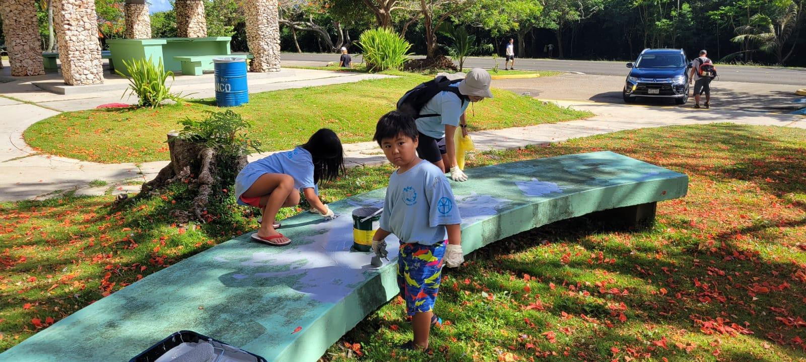 Children help paint benches during the Marianas Tourism Month cleanup on May 28, 2022, at the Last Command Post in Marpi, Saipan.