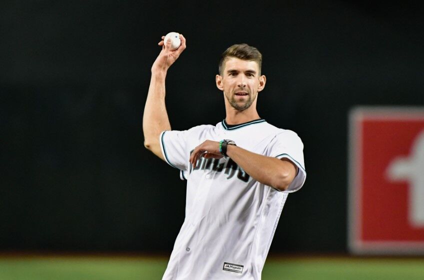 U.S. Olympic Gold Medal swimmer Michael Phelps throws a ceremonial first pitch prior to the game between the Arizona Diamondbacks and the Colorado Rockies at Chase Field in Phoenix, Az. on Aug 29, 2019.