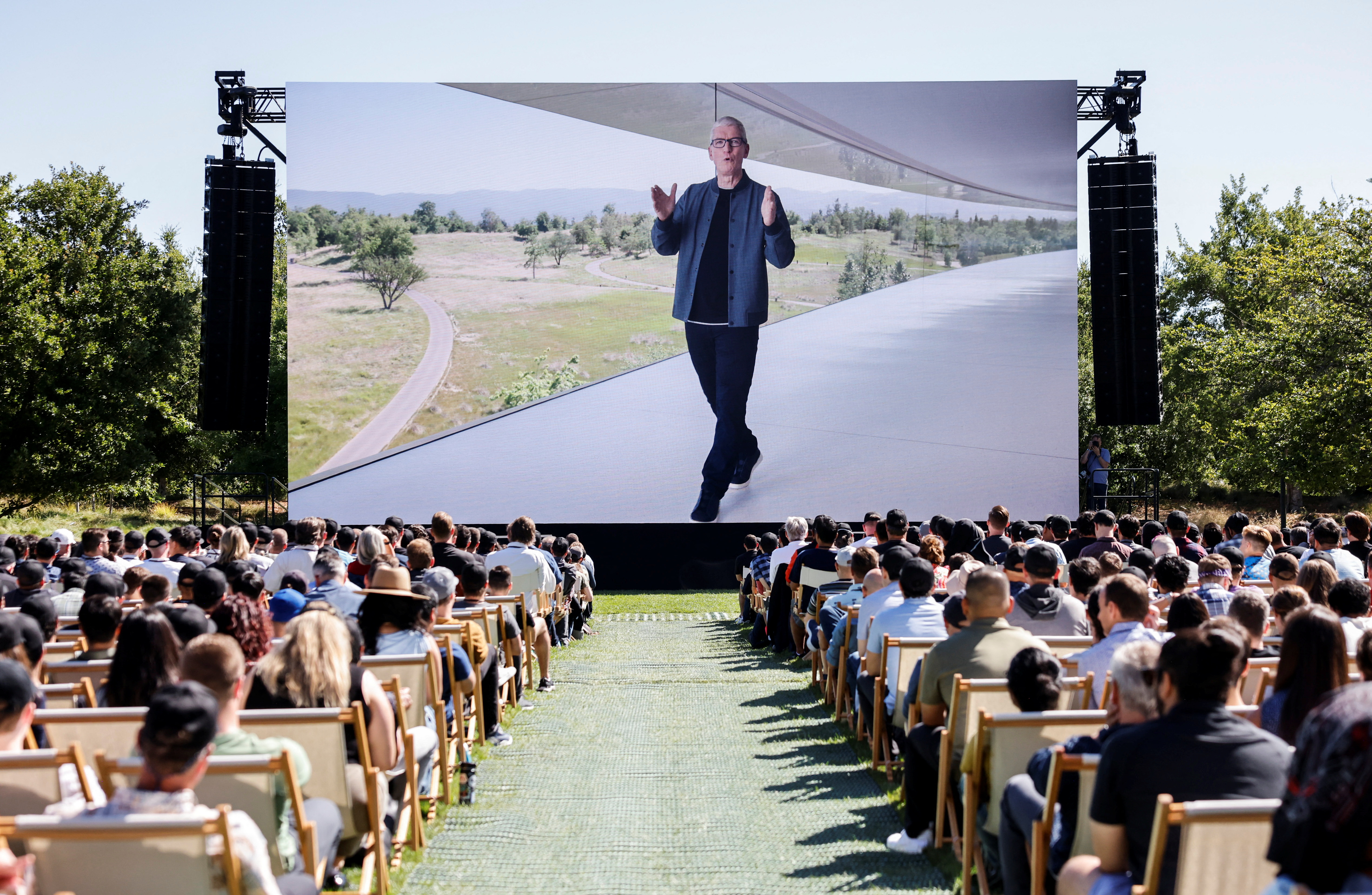 Apple CEO Tim Cook is displayed on a screen while speaking during Apple's annual Worldwide Developers Conference in San Jose, California, June 6, 2022.