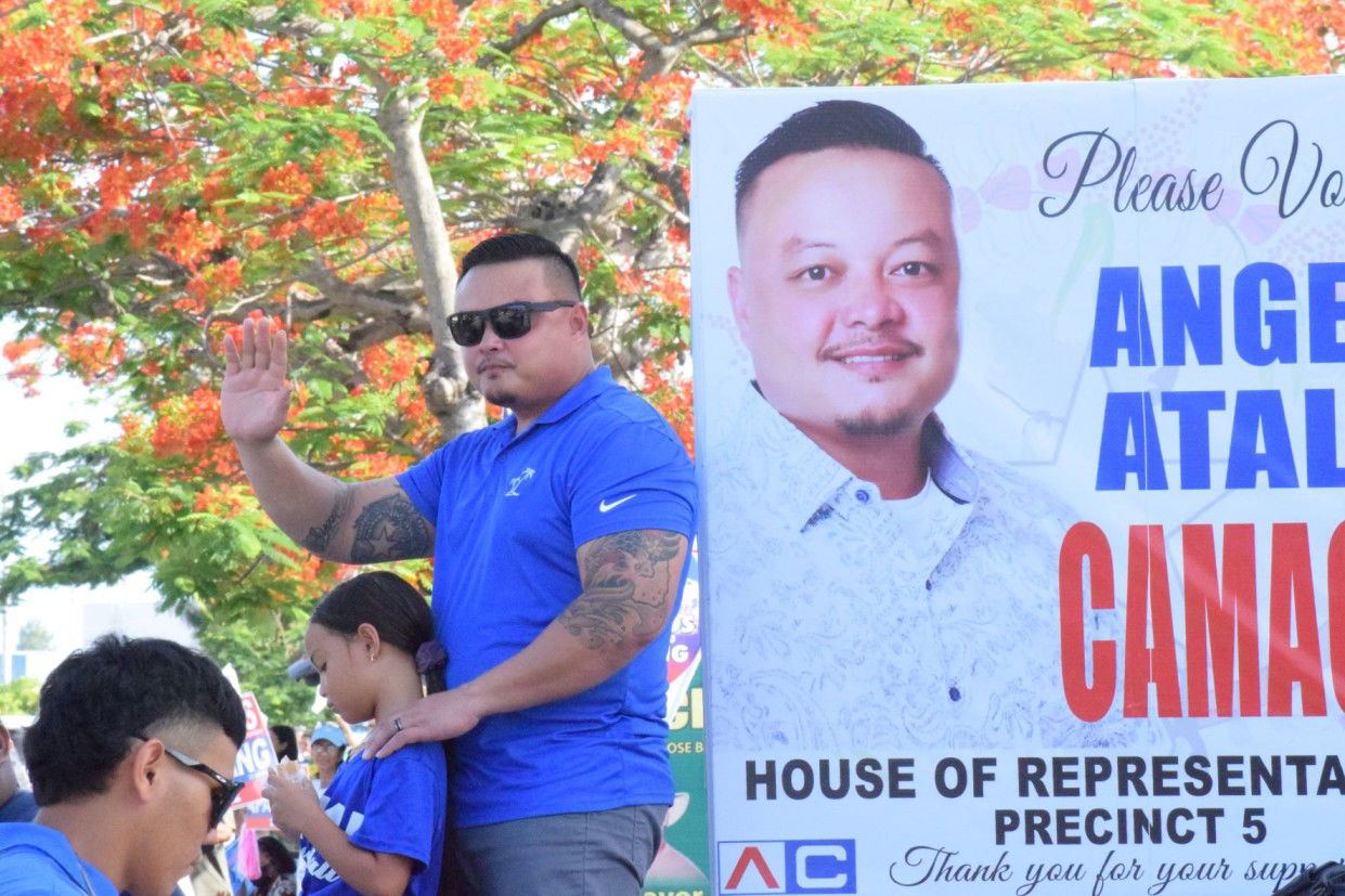 Precinct 5 independent House candidate Angel Atalig Camacho with his son.