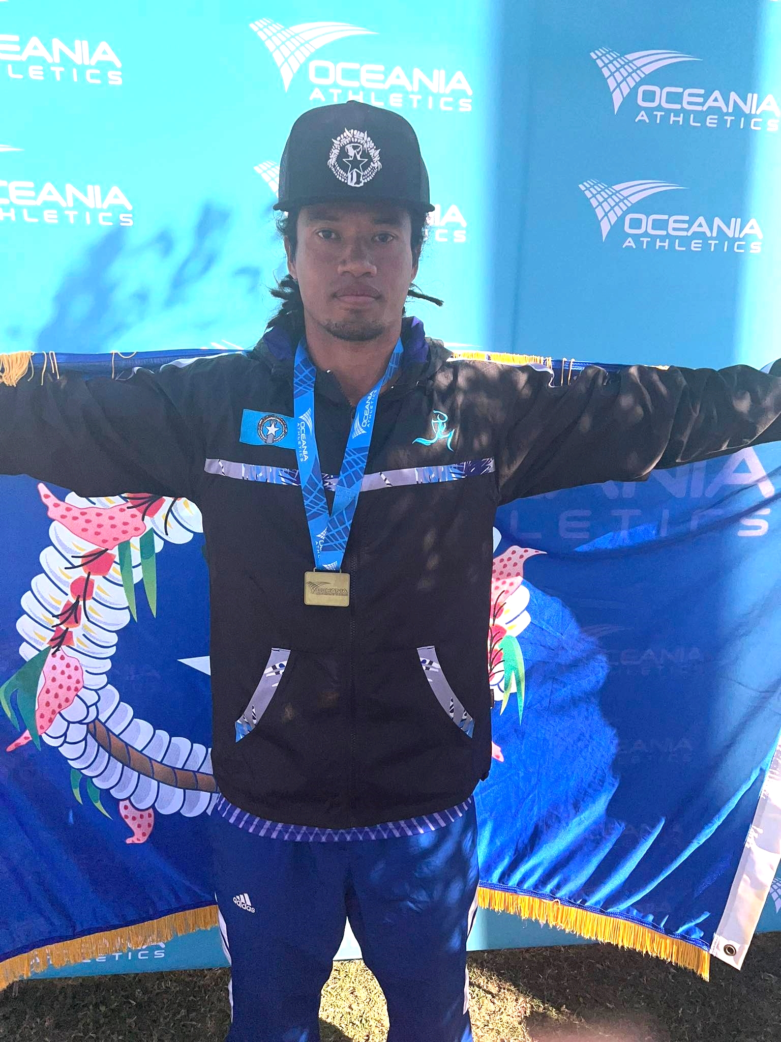 Orrin Pharmin poses with the gold medal he won in the Men's Masters High Jump event of the Oceania Athletics Championships in Mackay, Queensland, Australia.