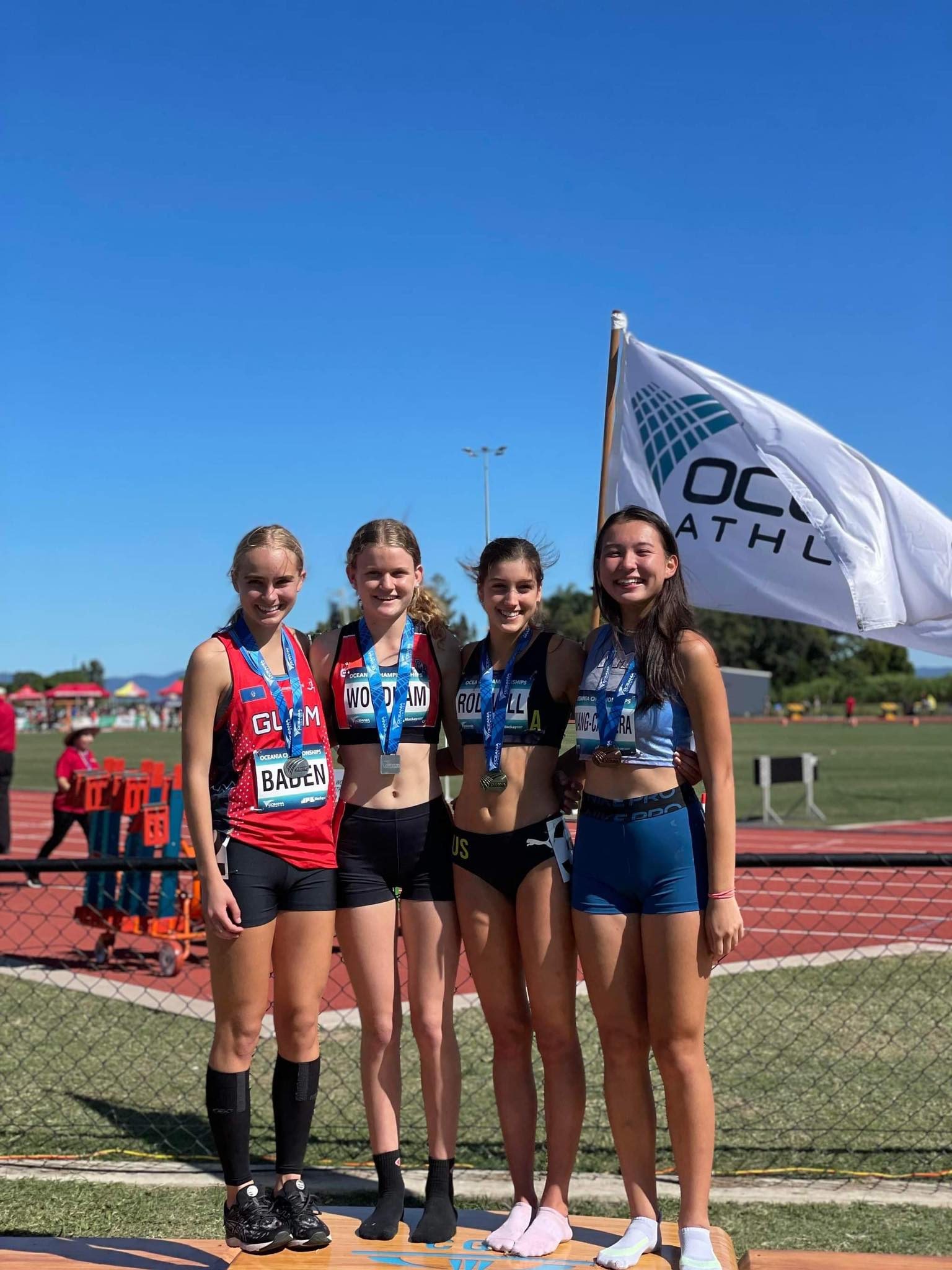 Tiana Cabrera, right, who won the bronze medal, poses  with the other medalists Thursday at the 2022 Oceania Athletics Championships in Mackay, Australia.