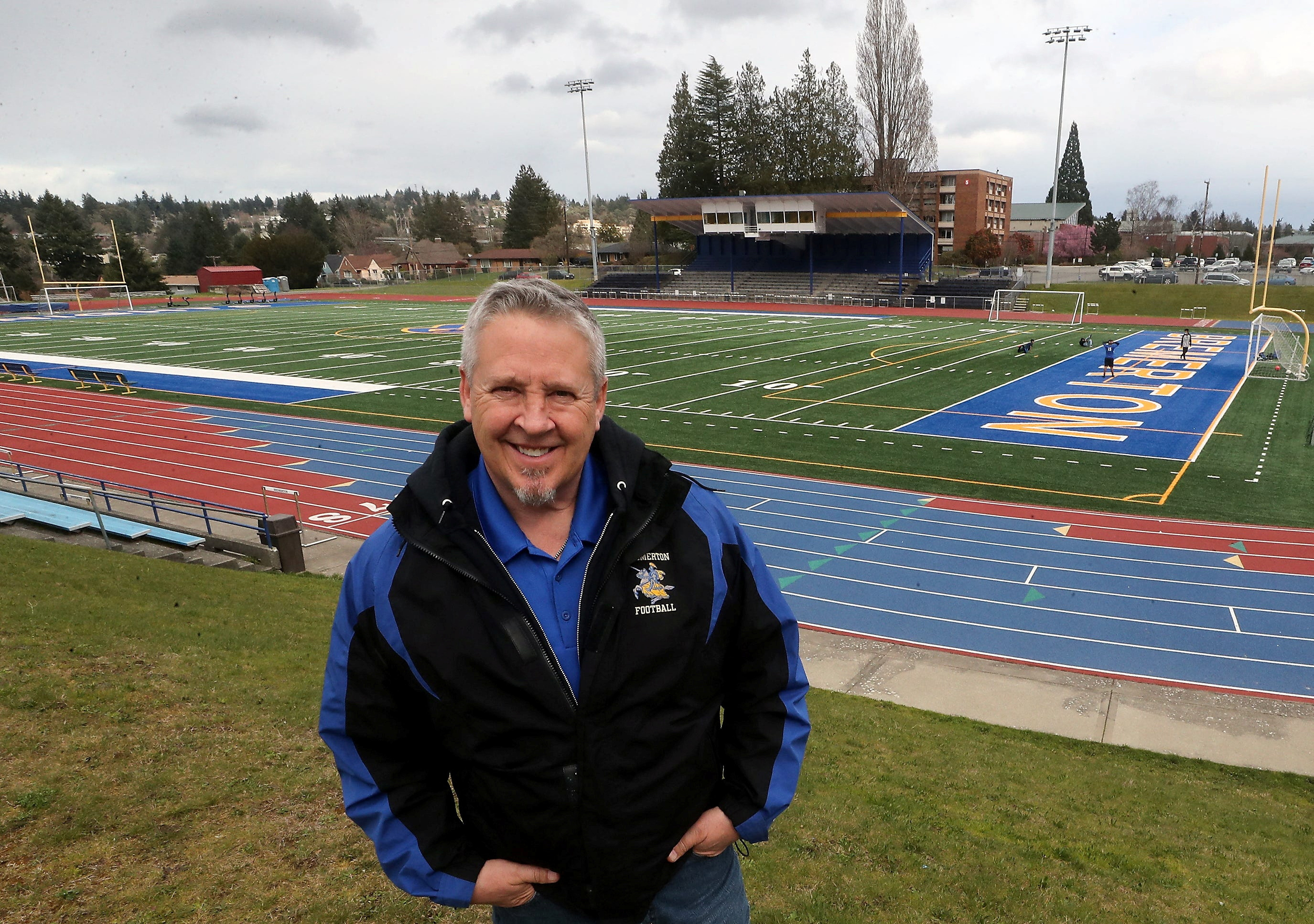 Joe Kennedy, a former public high school football coach in Washington state who sued after being suspended from his job for refusing to stop leading prayers with players on the field after games, poses at Bremerton Memorial Stadium in Bremerton, Washington, March 15, 2022.