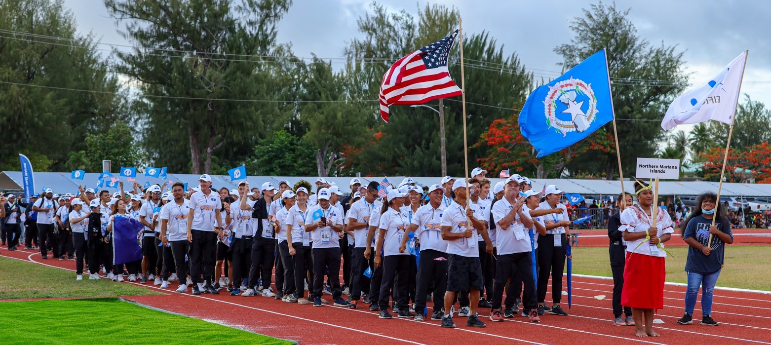 Athletes and officials of Team NMI make their way to the Oleai Sports Complex track oval during the opening ceremonies for the 2022 Northern Marianas Pacific Mini Games last week.