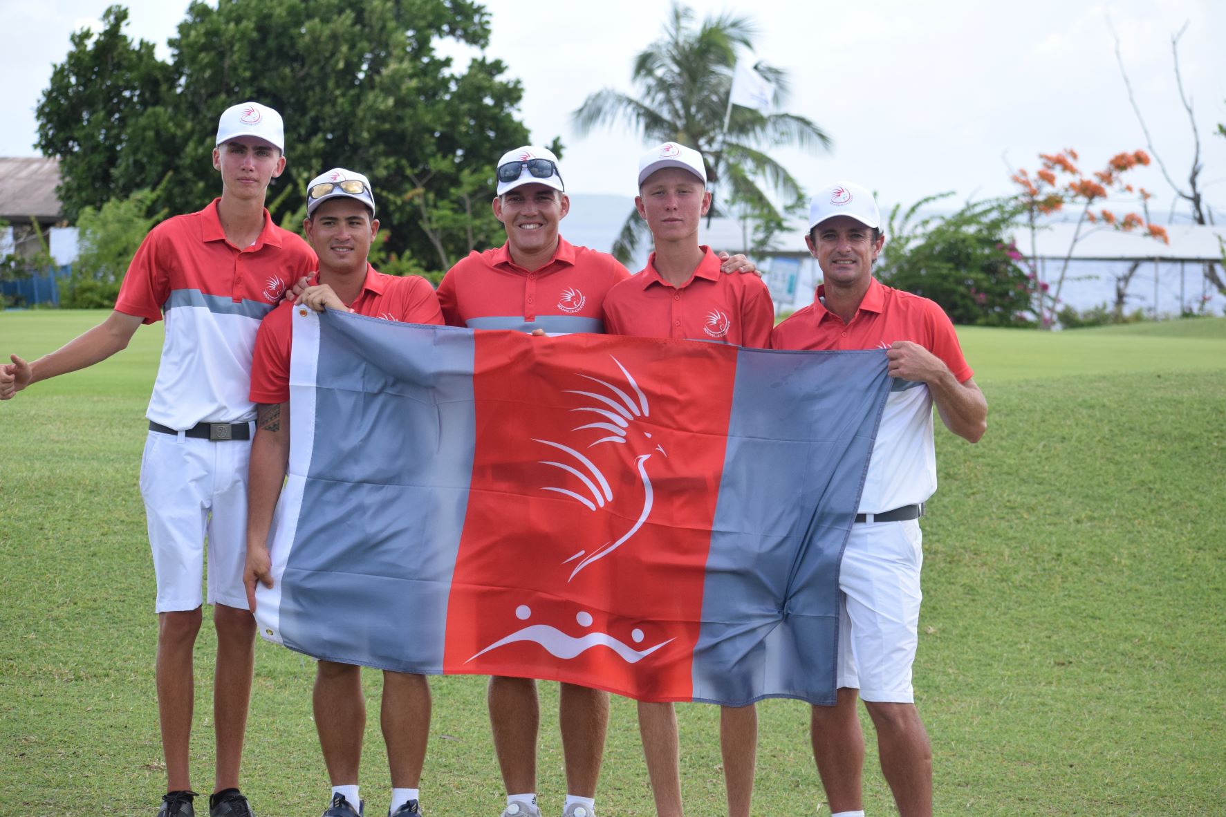 Men's golf gold medalist Koch Hugo, 2nd right, of New Caledonia with his team mates.