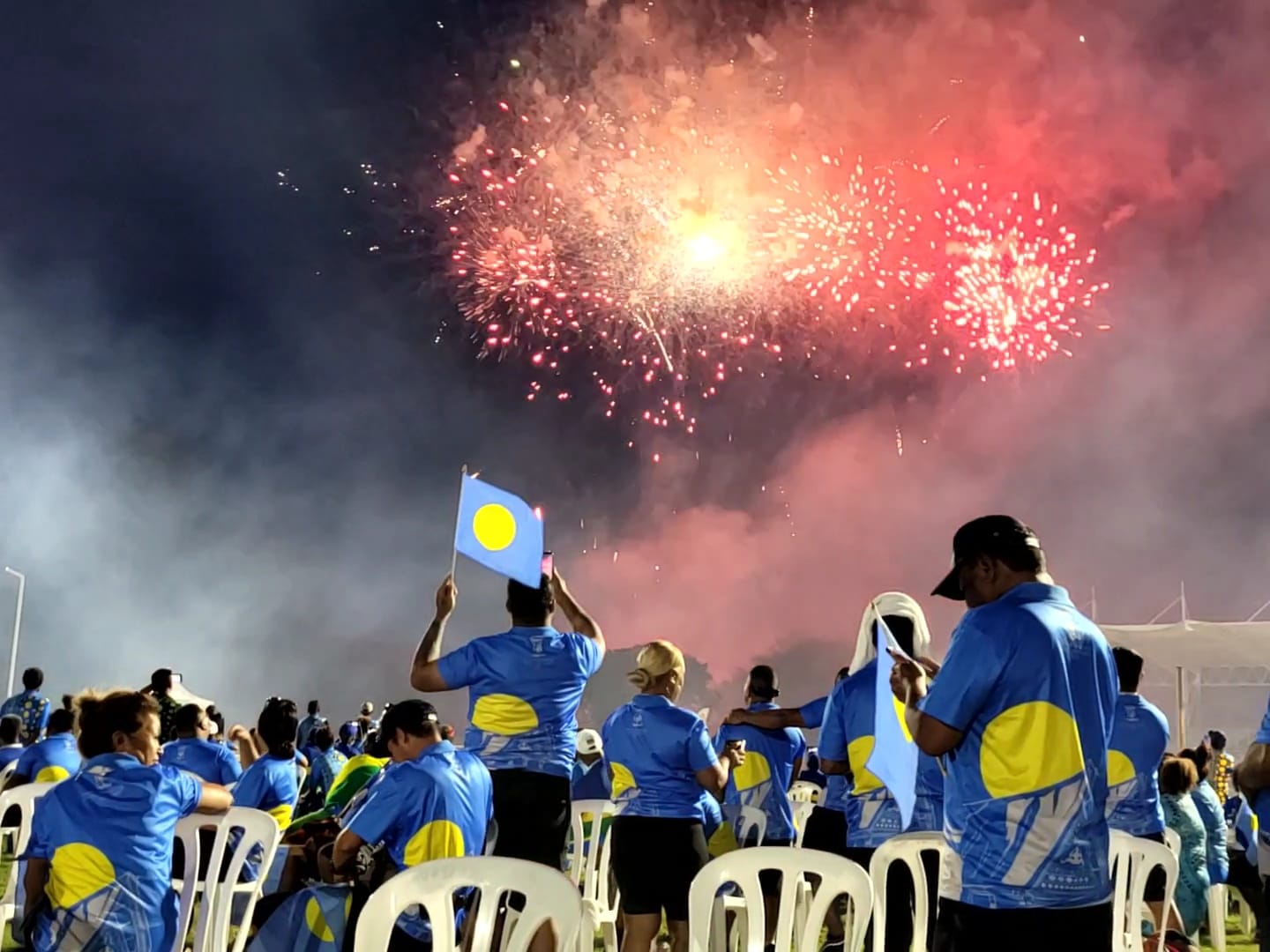 Palau delegation members watch the fireworks during the closing ceremony of the 2022 Pacific Mini Games on Saturday at the Oleai Sports Complex.