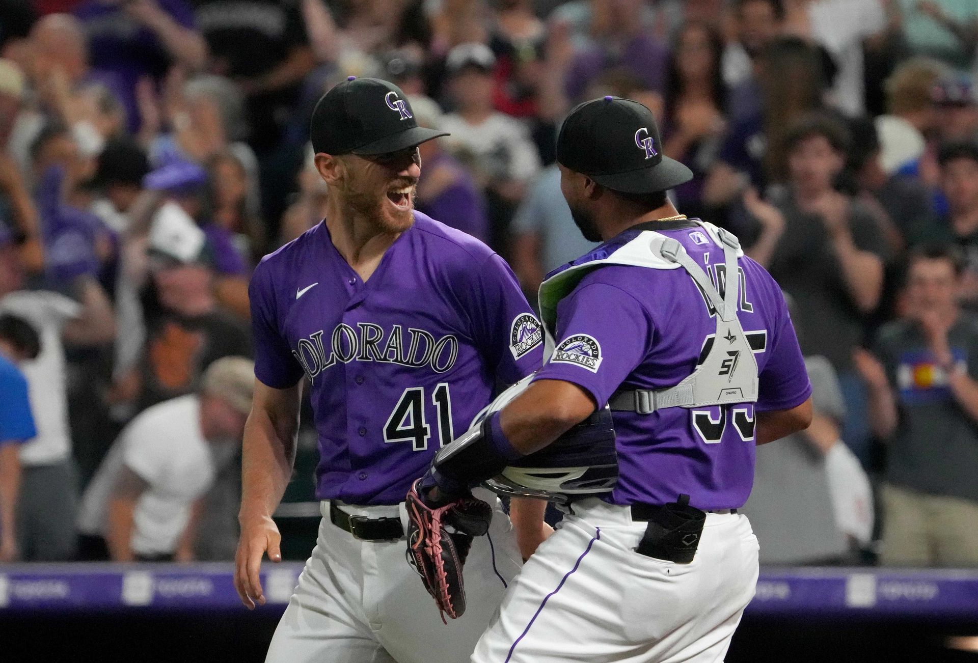 Colorado Rockies starting pitcher Chad Kuhl (41) and catcher Elias Diaz (35) celebrate defeating the Los Angeles Dodgers at Coors Field in Denver, Colorado on June 27, 2022.