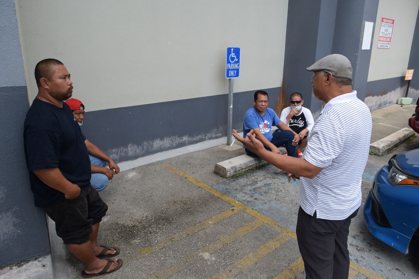Former Imperial Pacific International construction team leader Jesse Aquiningoc, right, gestures as he talks to his co-workers at the IPI construction site in Garapan last month. 