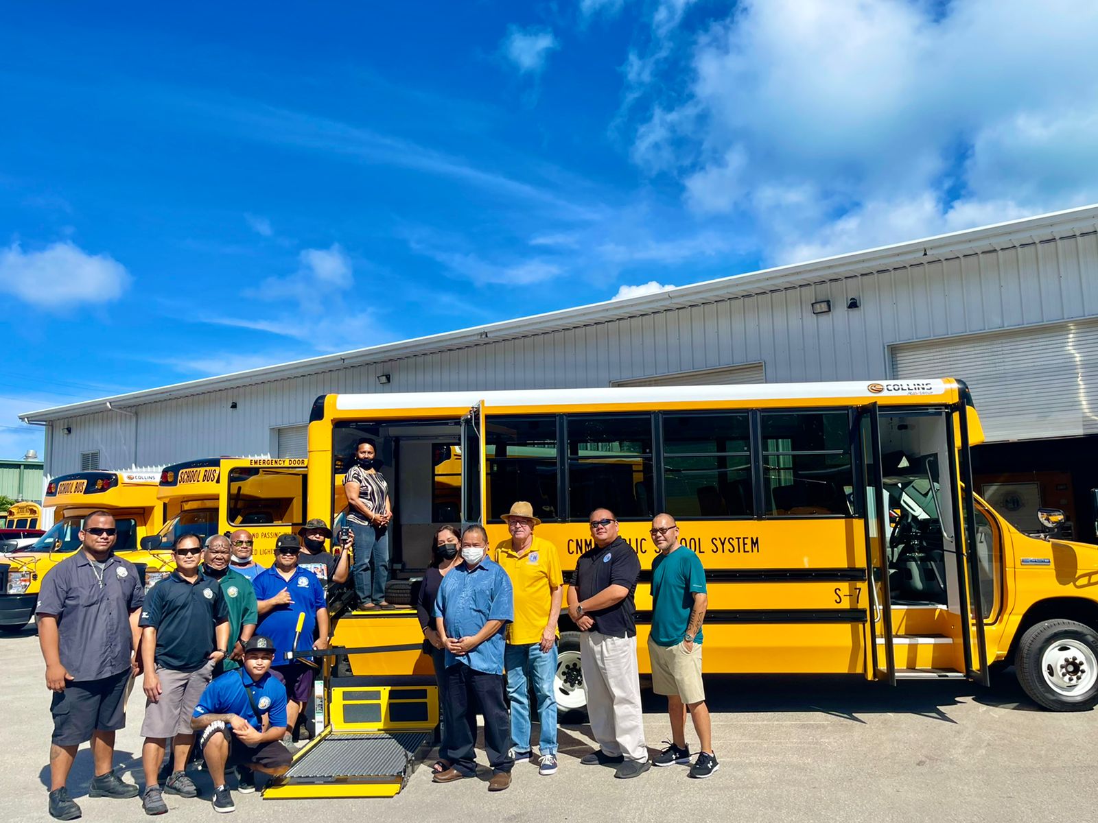 Commissioner of Education Dr. Alfred B. Ada, Associate Commissioner Eric Magofna, Special Education Program Director Donna Flores and PSS Federal Programs Officer Tim Thornburgh receive the four new mini buses delivered  Wednesday at the PSS Office of Pupil Transportation in Lower Base.