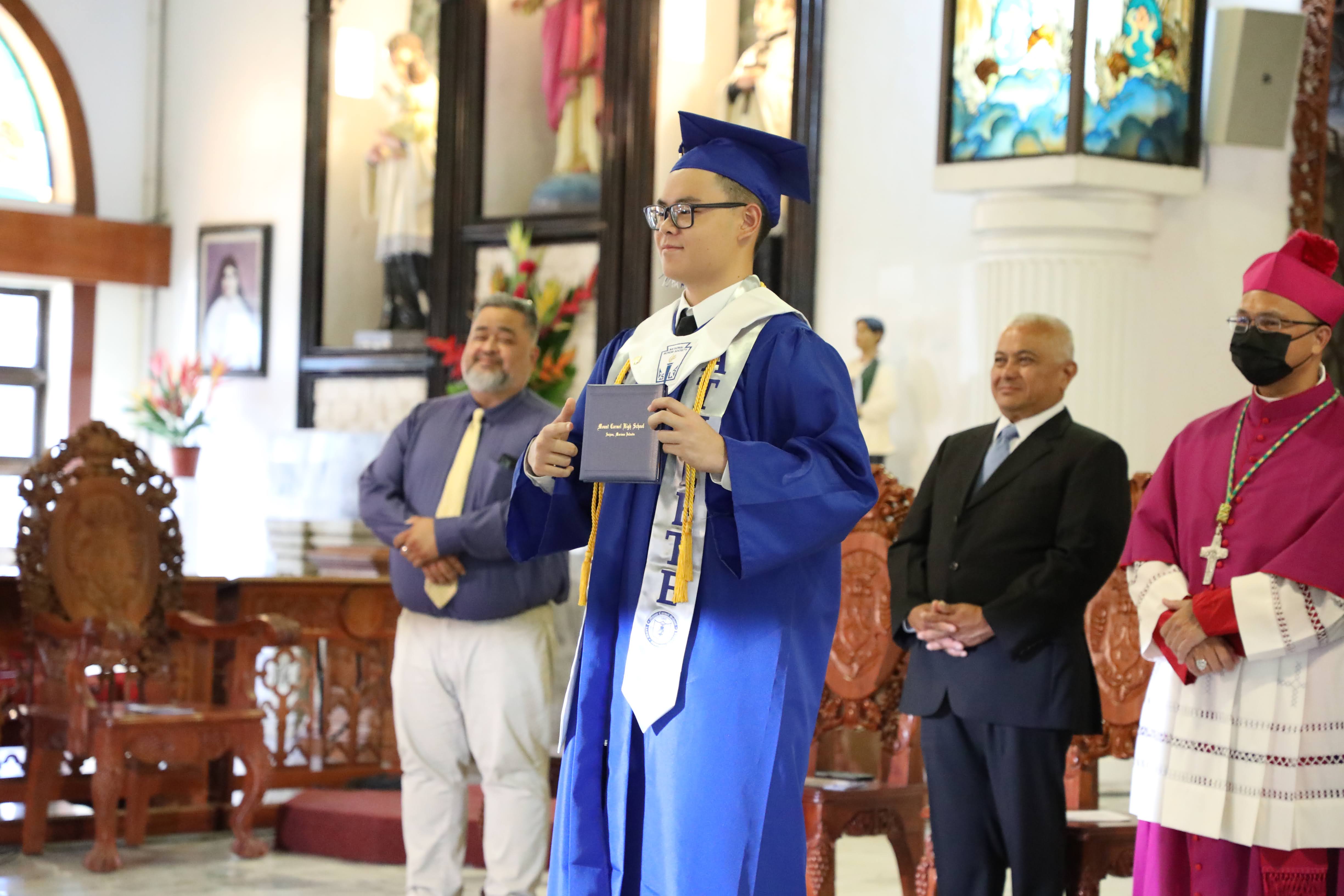Mount Carmel School student Jefferey Yue Sheu receives his diploma during the school’s 12th-grade commencement ceremony on June 4, 2022.