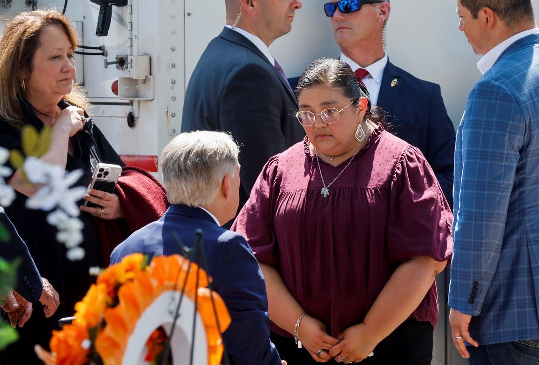 Texas Gov. Greg Abbott speaks with Mandy Gutierrez, principal at Robb Elementary School, where a gunman killed 19 children and two teachers in the deadliest U.S. school shooting in nearly a decade, during President Joe Biden's visit at the school, in Uvalde, Texas, May 29, 2022.