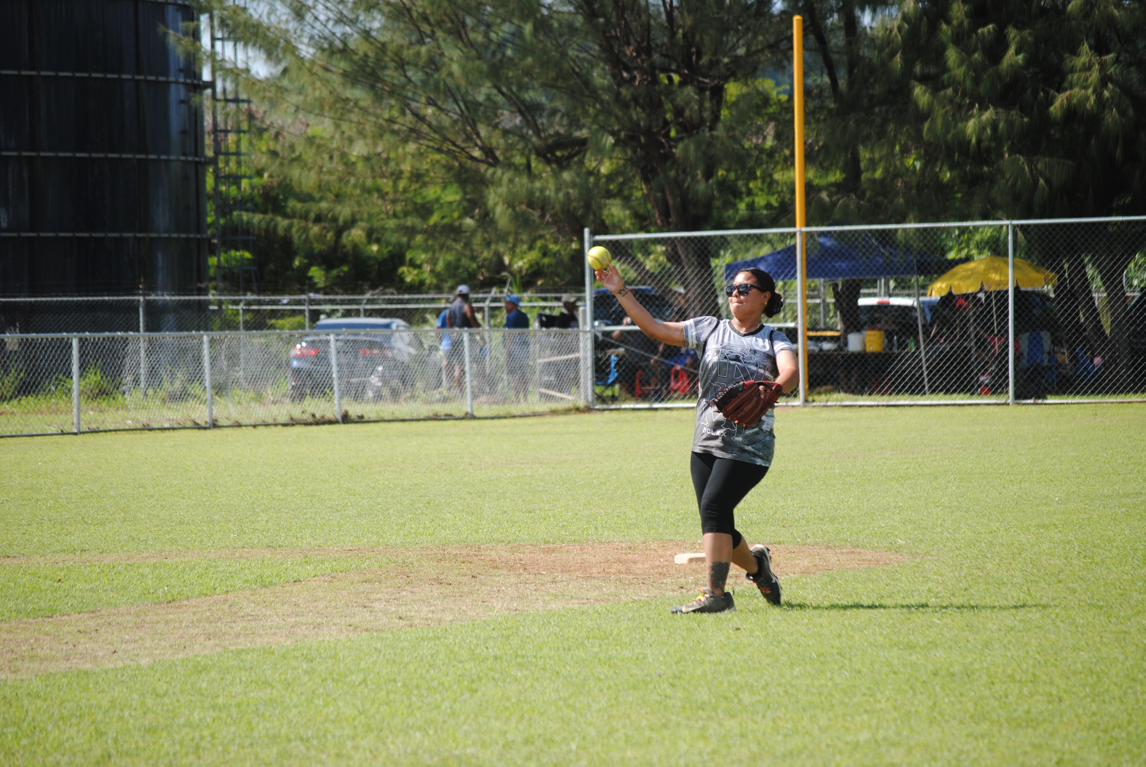 Hotshots' second baseman Bex throws to first base for the out.
