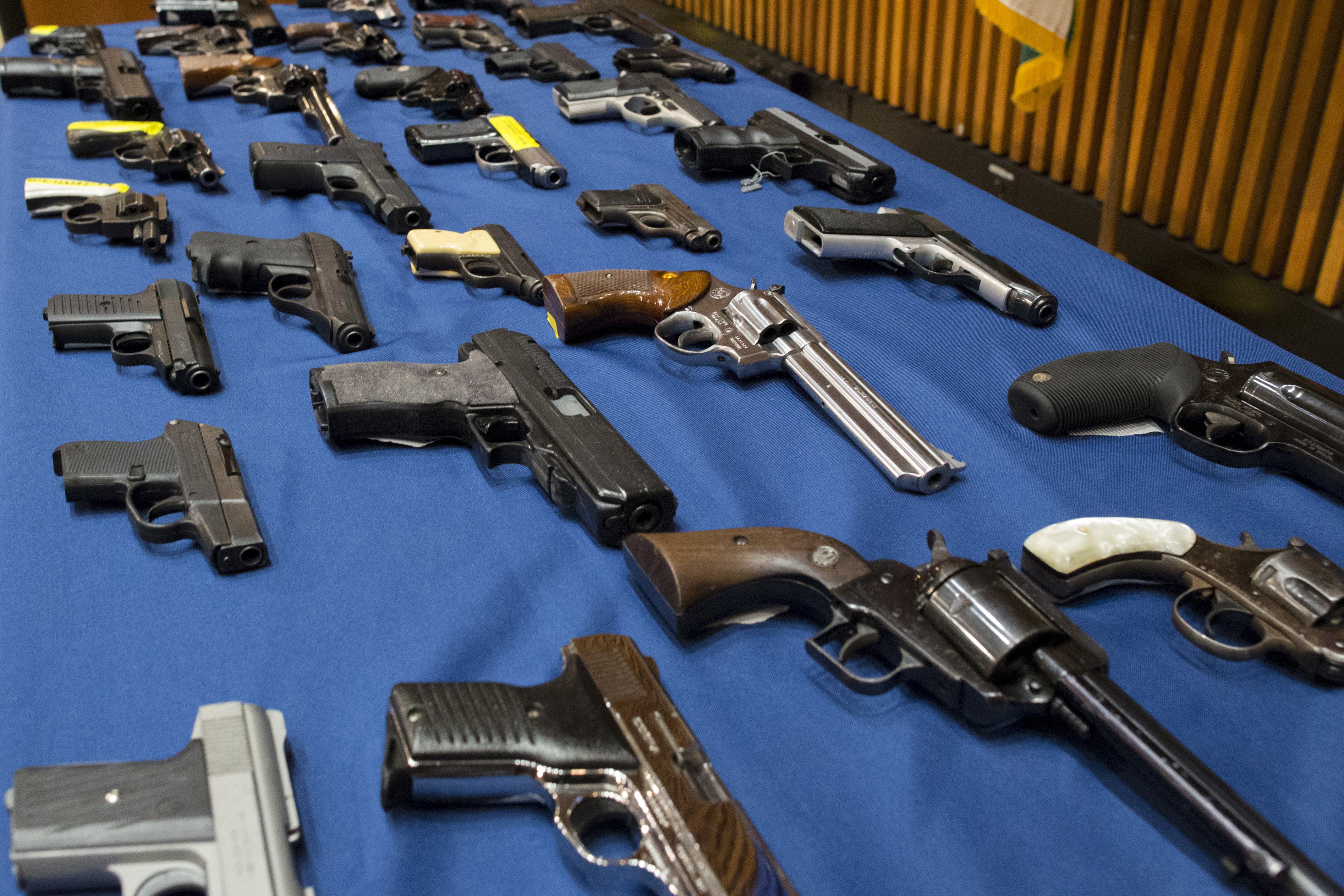 Confiscated illegal guns are displayed during a news conference at New York City Police Headquarters in New York, Oct. 27, 2015.