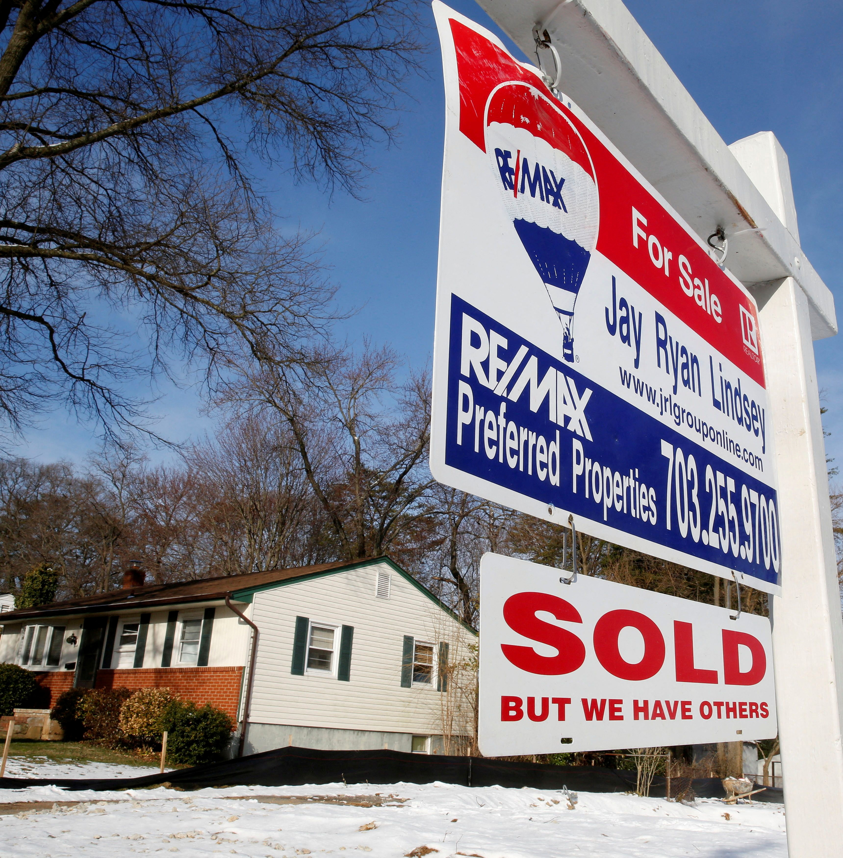 A "SOLD" sign hangs in front of a house in Vienna in Virginia on March 27, 2014.